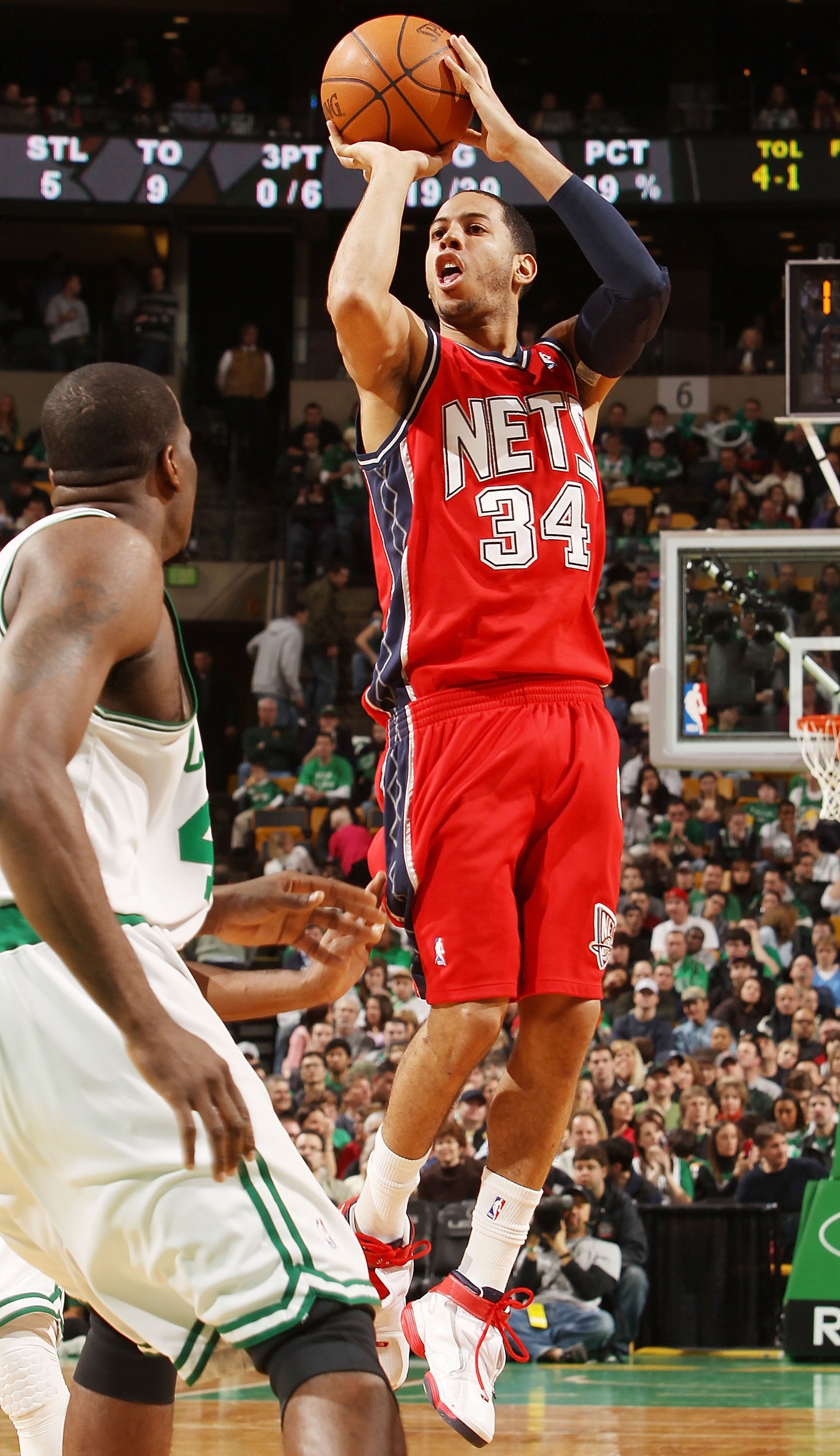 BOSTON - FEBRUARY 27:  Devin Harris #34 of the New Jersey Nets takes a shot as Kendrick Perkins #43 of the Boston Celtics defends at the TD Garden on February 27, 2010 in Boston, Massachusetts. The Nets defeated the Celtics 104-96.  NOTE TO USER: User exp
