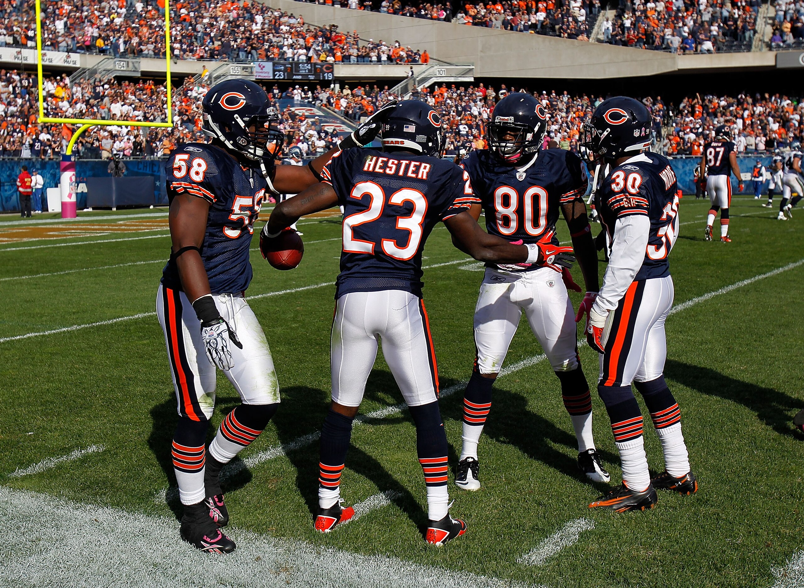 CHICAGO - OCTOBER 17: Devin Hester #23 of the Chicago Bears celebrates with teammates (L-R) Rod Wilson #58, Earl Bennett #80 and D.J. Moore #30 after returning a punt 89 years for a touchdown in the 4th quarter against the Seattle Seahawks at Soldier Fiel