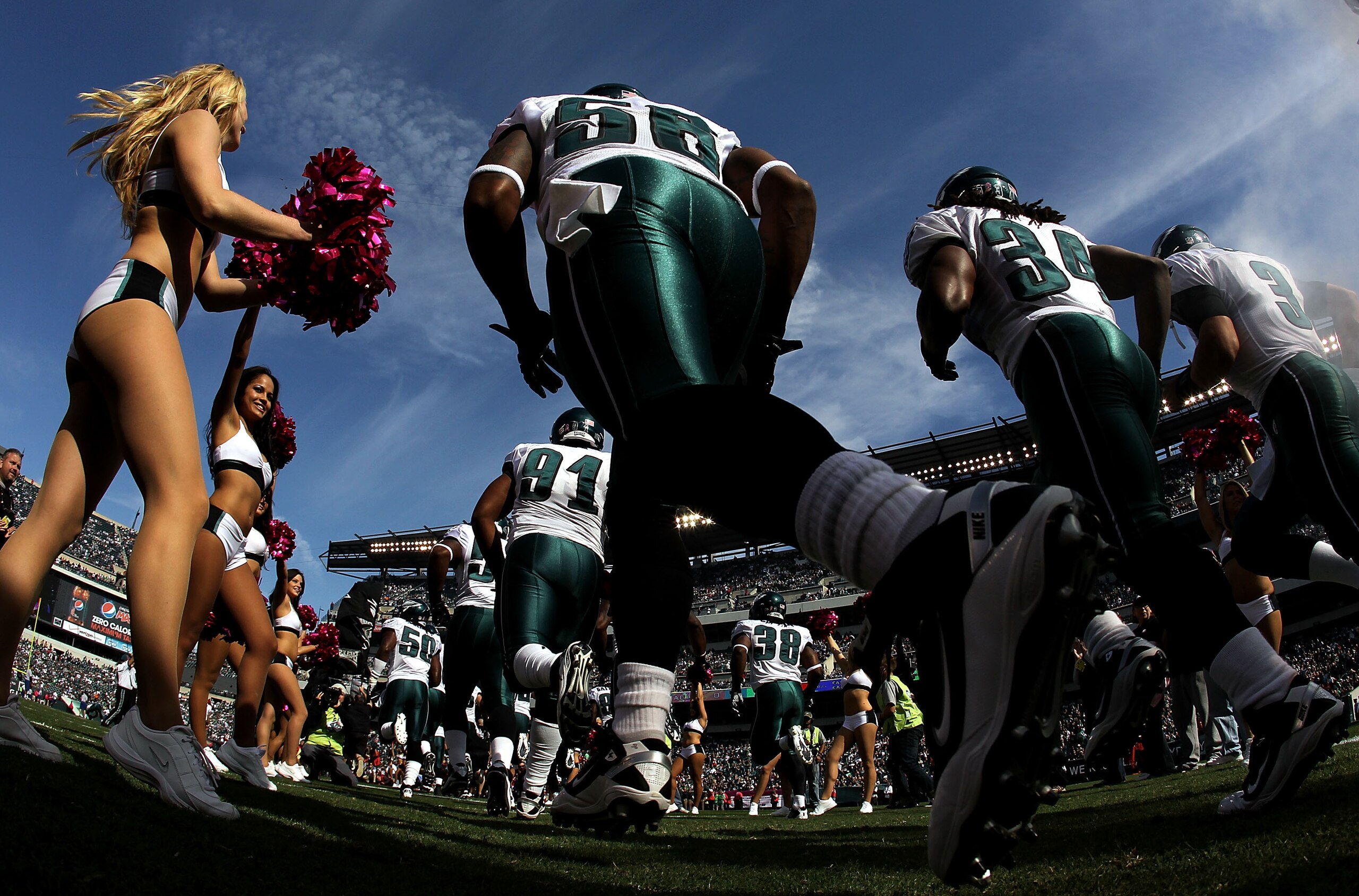 PHILADELPHIA - OCTOBER 17:  A Philadelphia Eagles cheerleader greets the Eagles as they take the field against the Atlanta Falcons during their game at Lincoln Financial Field on October 17, 2010 in Philadelphia, Pennsylvania.  (Photo by Al Bello/Getty Im