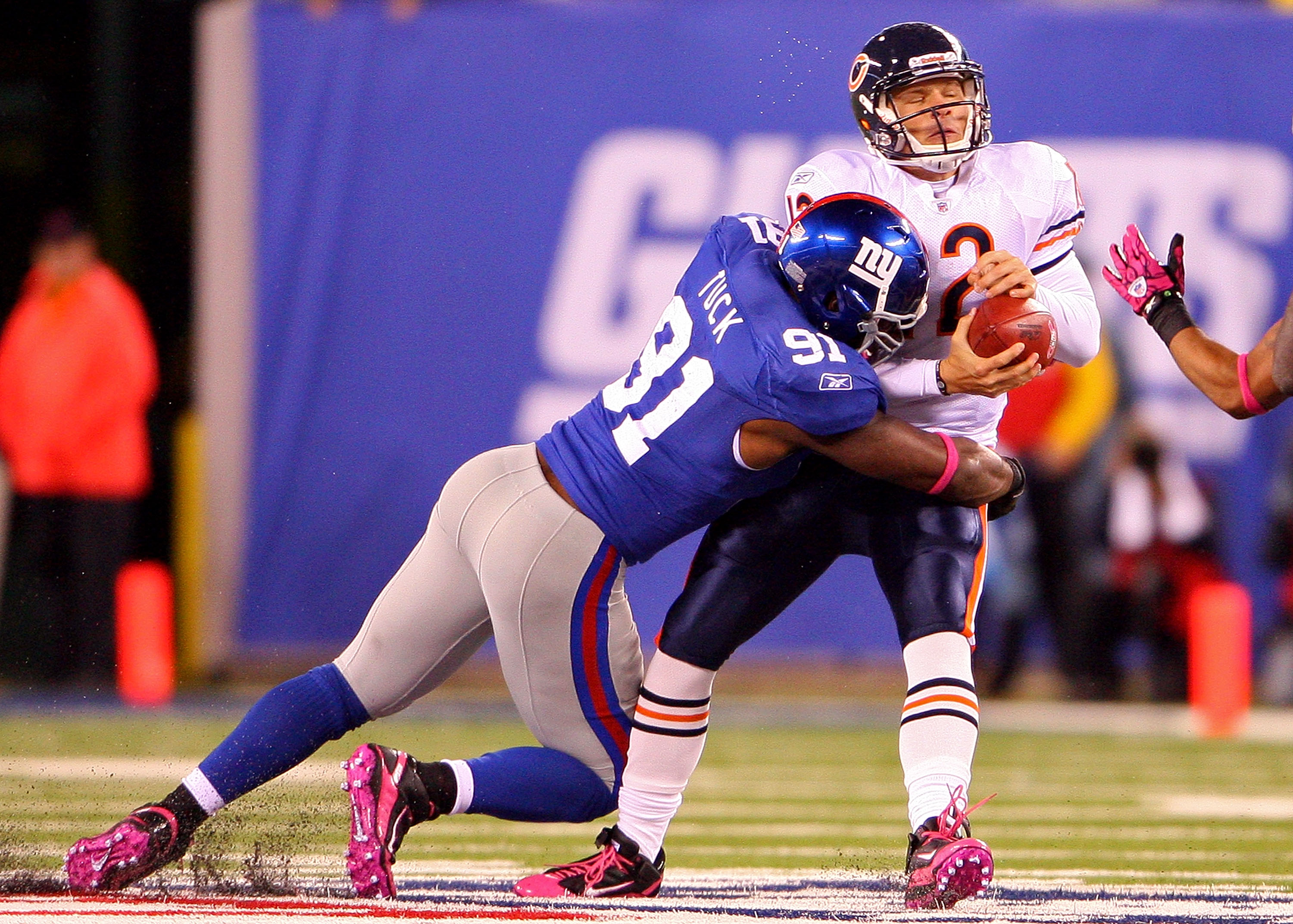 EAST RUTHERFORD, NJ - OCTOBER 03:  Justin Tuck #91 of the New York Giants sacks Caleb Hanie #12 of the Chicago Bear at New Meadowlands Stadium on October 3, 2010 in East Rutherford, New Jersey.  (Photo by Andrew Burton/Getty Images)