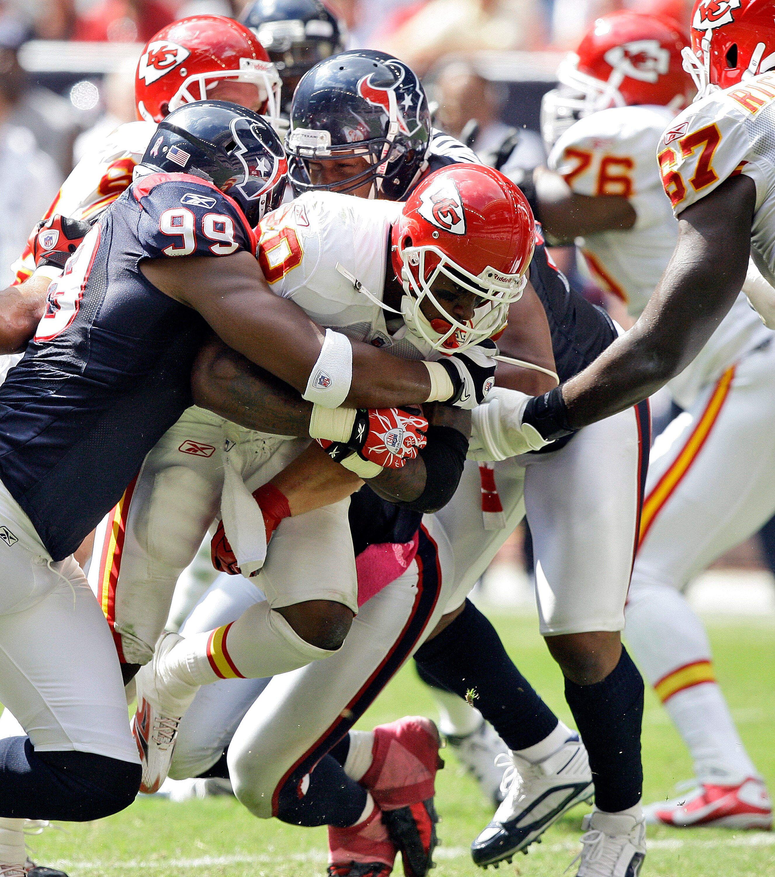 HOUSTON - OCTOBER 17:  Running back Thomas Jones #30 of the Kansas City Chiefs is tackled by Adewale Ogunleye #99 of the Houston Texans at Reliant Stadium on October 17, 2010 in Houston, Texas.  (Photo by Bob Levey/Getty Images)