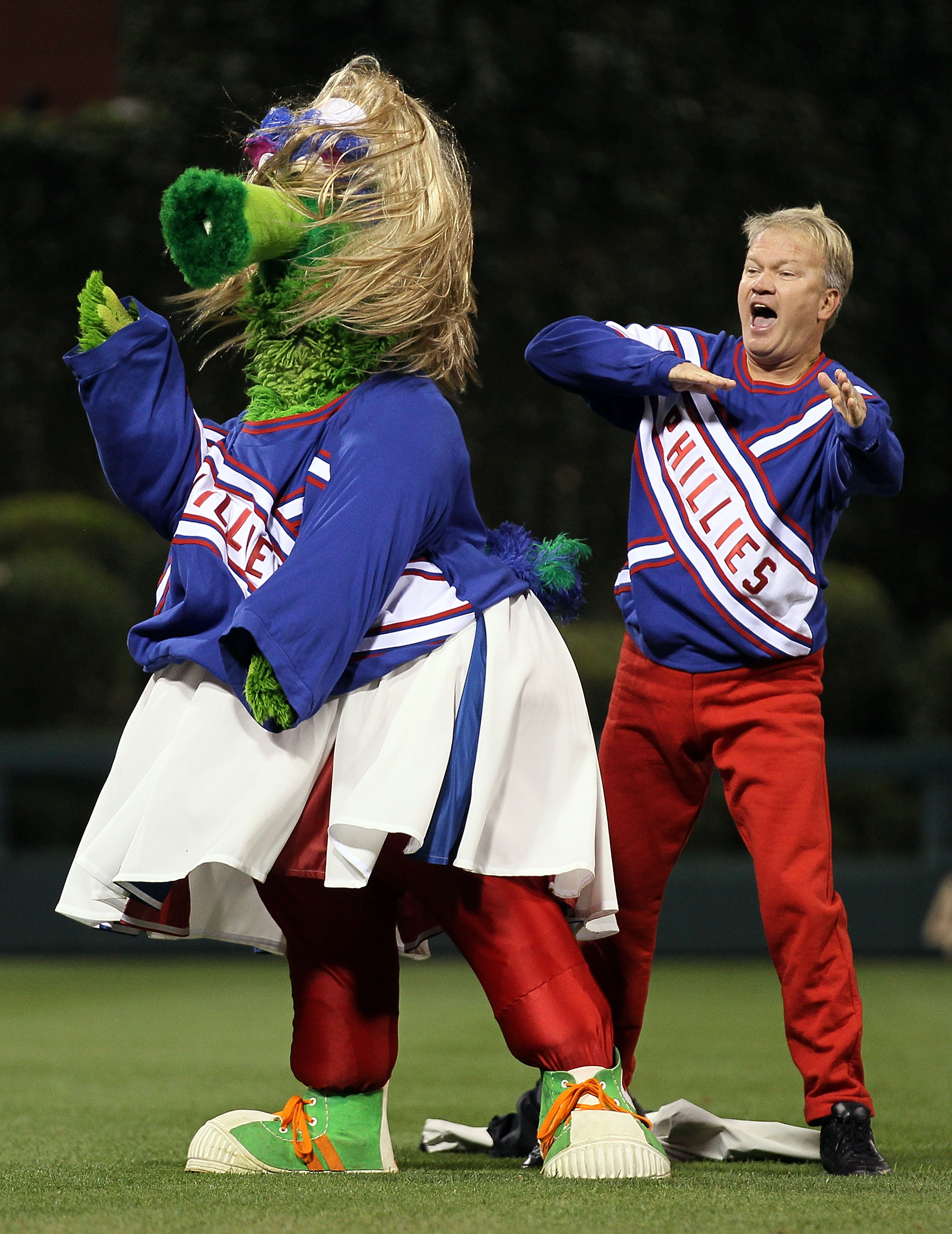 PHILADELPHIA - OCTOBER 16:  The Phillie Phanatic performs with a male performer during Game One of the NLCS during the 2010 MLB Playoffs between the Philadelphia Phillies and the San Francisco Giants at Citizens Bank Park on October 16, 2010 in Philadelph