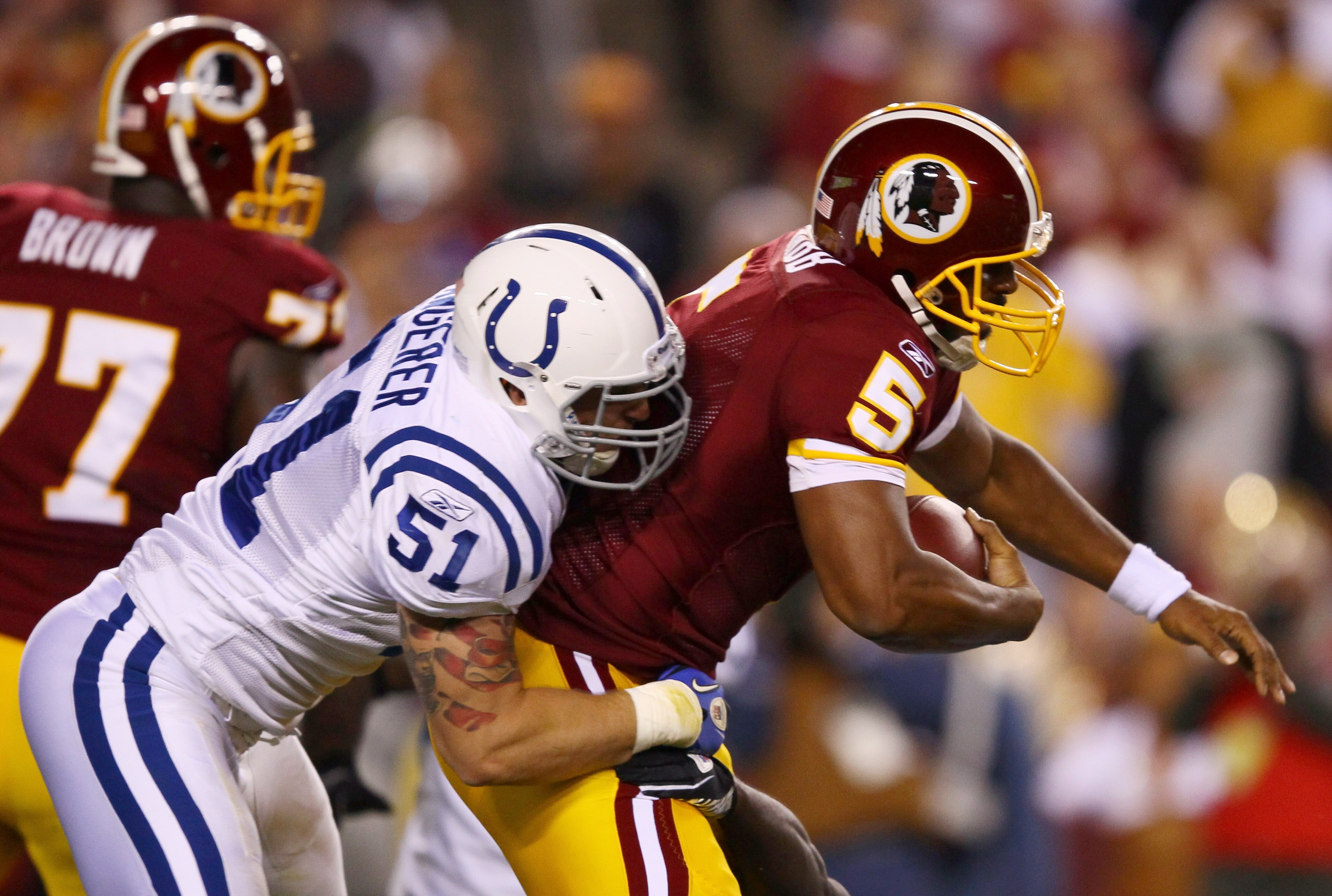 LANDOVER, MD - OCTOBER 17:  Quarterback Donovan McNabb #5 of the Washington Redskins is sacked by Pat Angerer #51 of the Indianapolis Colts in first quarter action at FedExField on October 17, 2010 in Landover, Maryland.  (Photo by Win McNamee/Getty Image