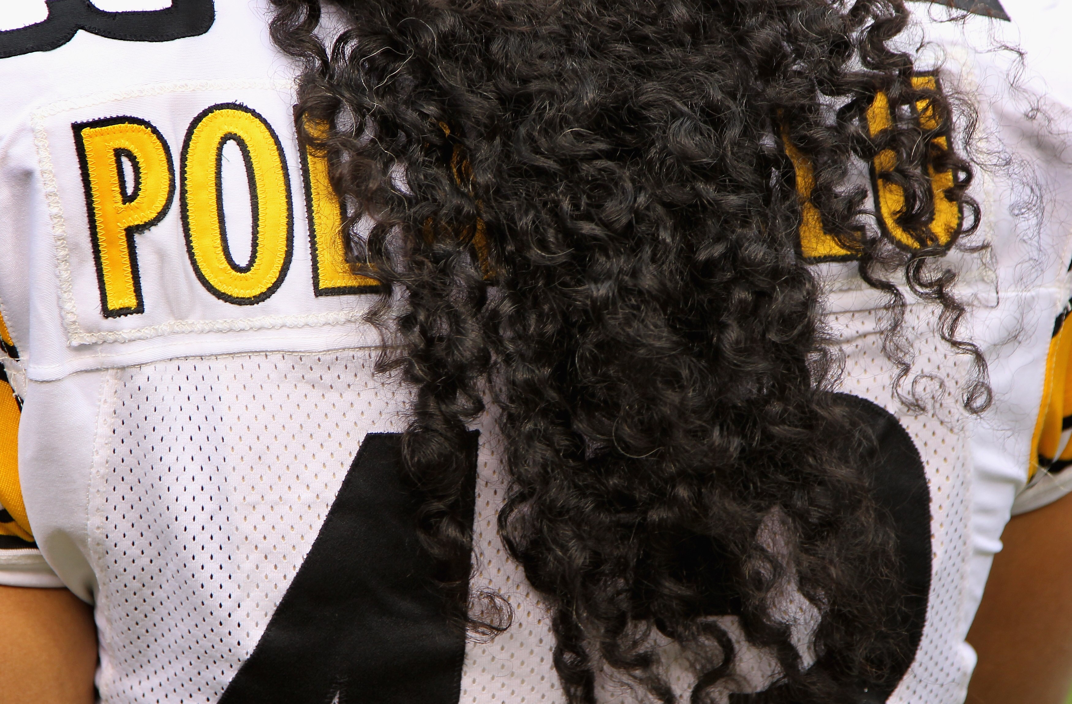 DENVER - AUGUST 29:  The name on the back of the jersey of safety Troy Polamalu #43 of the Pittsburgh Steelers is obscured by his hair as he defends against the Denver Broncos during preseason NFL action at INVESCO Field at Mile High on August 29, 2010 in