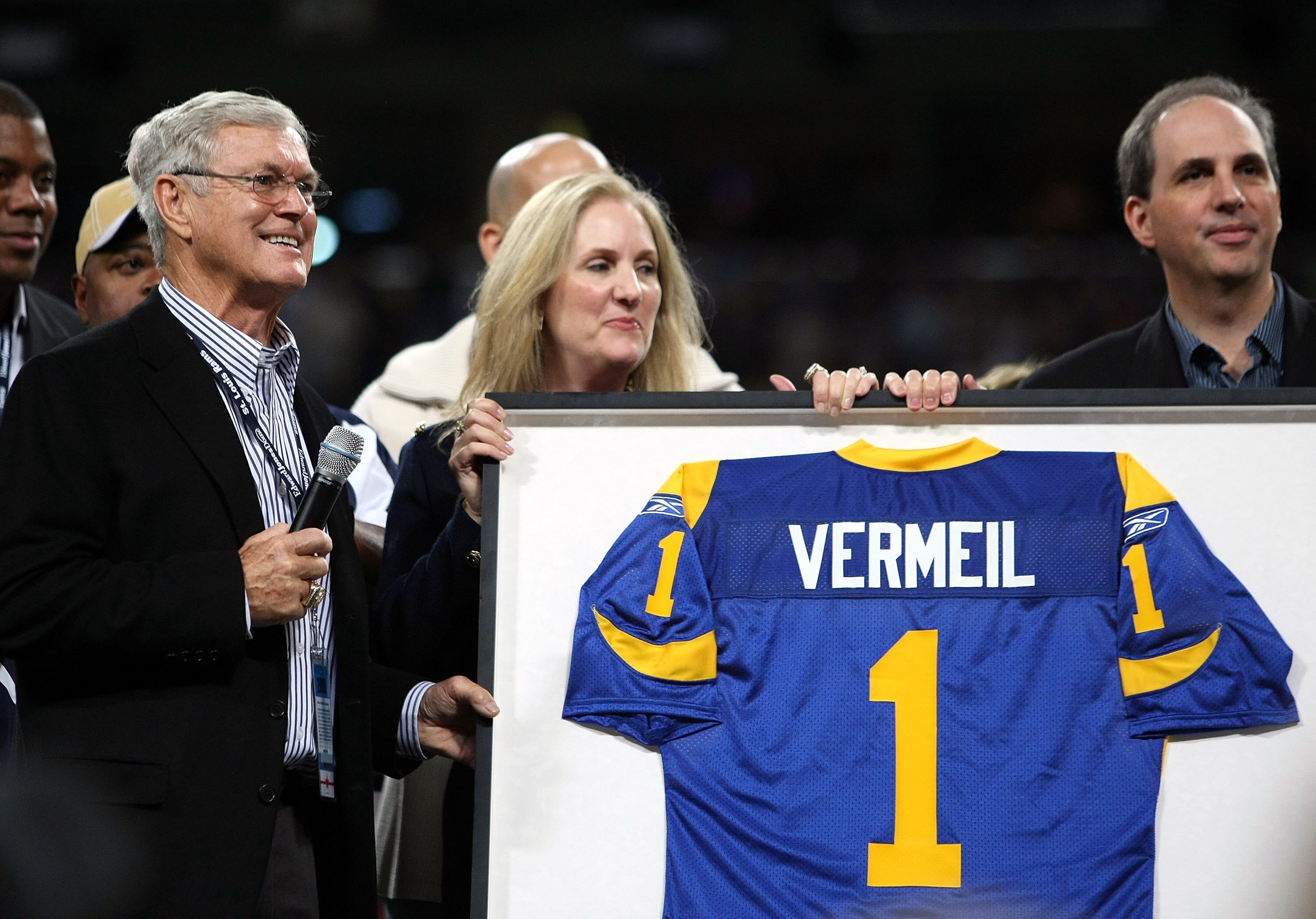 ST. LOUIS - NOVEMBER 02:  St. Louis Rams former head coach Dick Vermeil is given a jersey by owners Lucia Rodriguez and Chip Rosenbloom during a ceremony honoring the coach during halftime of the St. Louis Rams versus the Arizona Cardinals game on Novembe