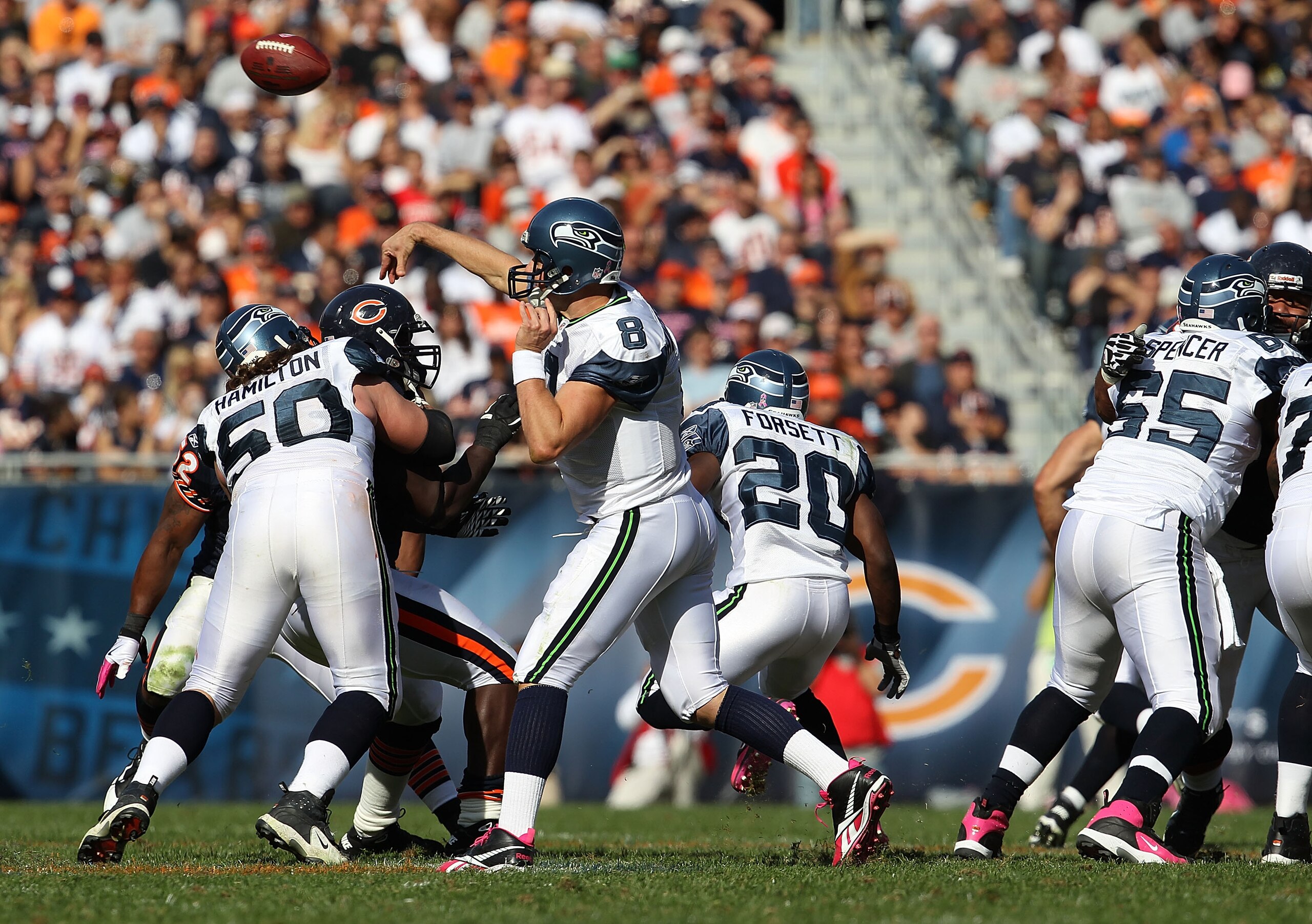 CHICAGO - OCTOBER 17: Matt Hasselbeck #8 of the Seattle Seahawks passes the ball against the Chicago Bears as teammates Ben Hamilton #50 and Chris Spencer #65 block at Soldier Field on October 17, 2010 in Chicago, Illinois. The Seahawks defeated the Bears