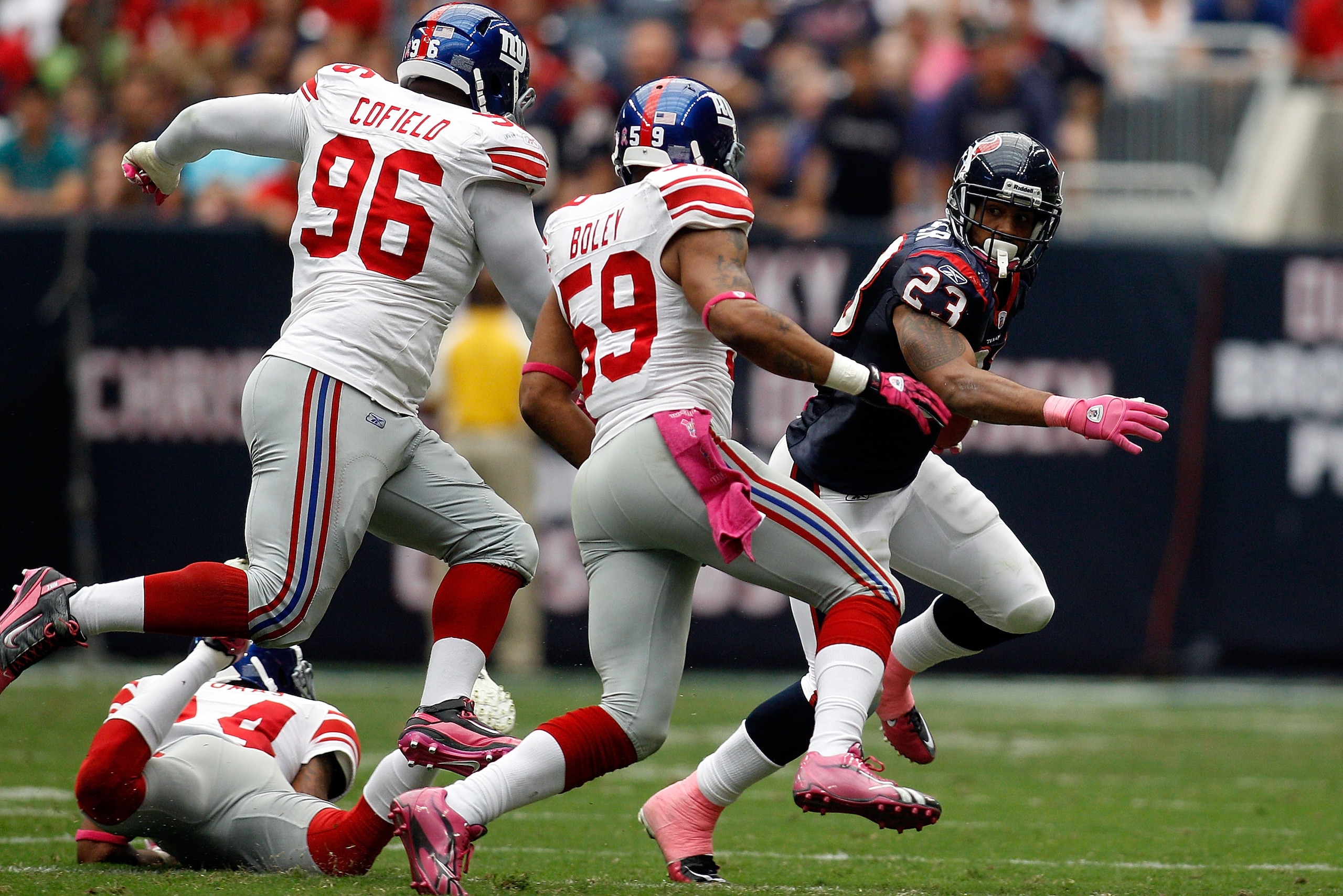 HOUSTON - OCTOBER 10:  Arian Foster #23 of the Houston Texans is chased by the New York Giants defense at Reliant Stadium on October 10, 2010 in Houston, Texas.  The Giants defeated the Texans 34-10.  (Photo by Chris Graythen/Getty Images)