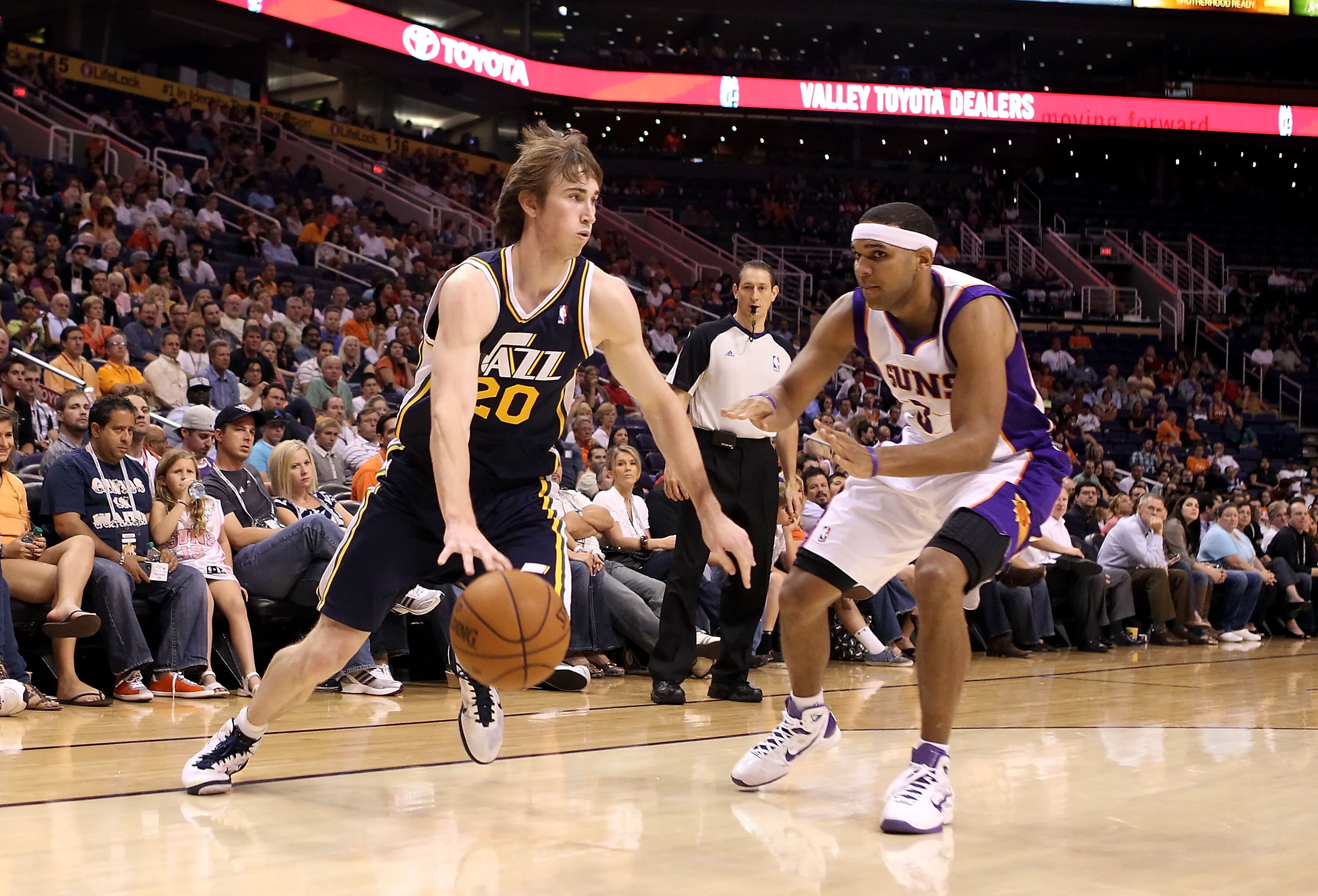 PHOENIX - OCTOBER 12:  Gordon Hayward #20 of the Utah Jazz drives the ball past Jared Dudley #3 of the Phoenix Suns during the preseason NBA game at US Airways Center on October 12, 2010 in Phoenix, Arizona. NOTE TO USER: User expressly acknowledges and a