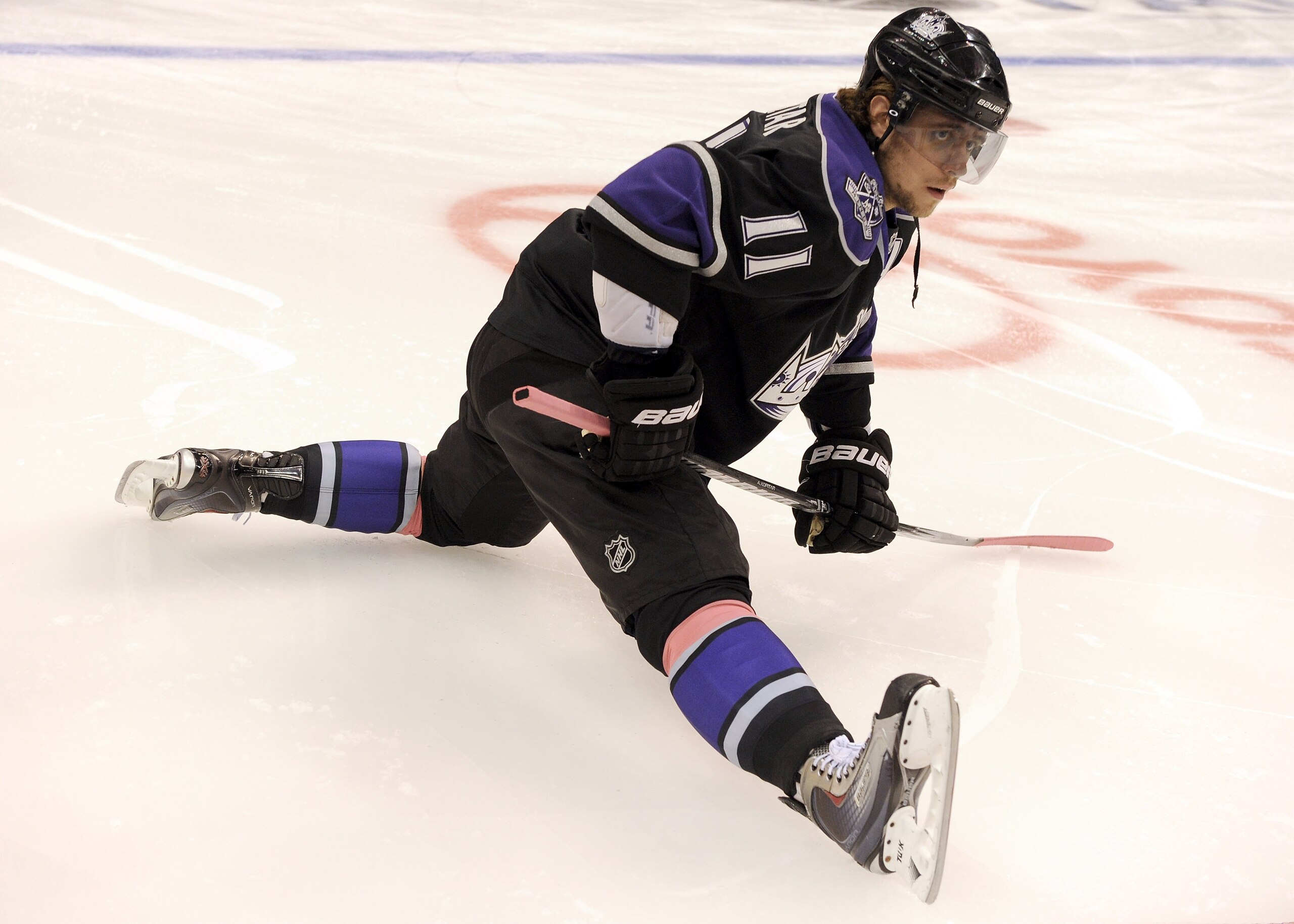 LOS ANGELES, CA - OCTOBER 15:  Anze Kopitar #11 of the Los Angeles Kings stretches during warm up against the Vancouver Canucks at the Staples Center on October 15, 2010 in Los Angeles, California.  (Photo by Harry How/Getty Images)