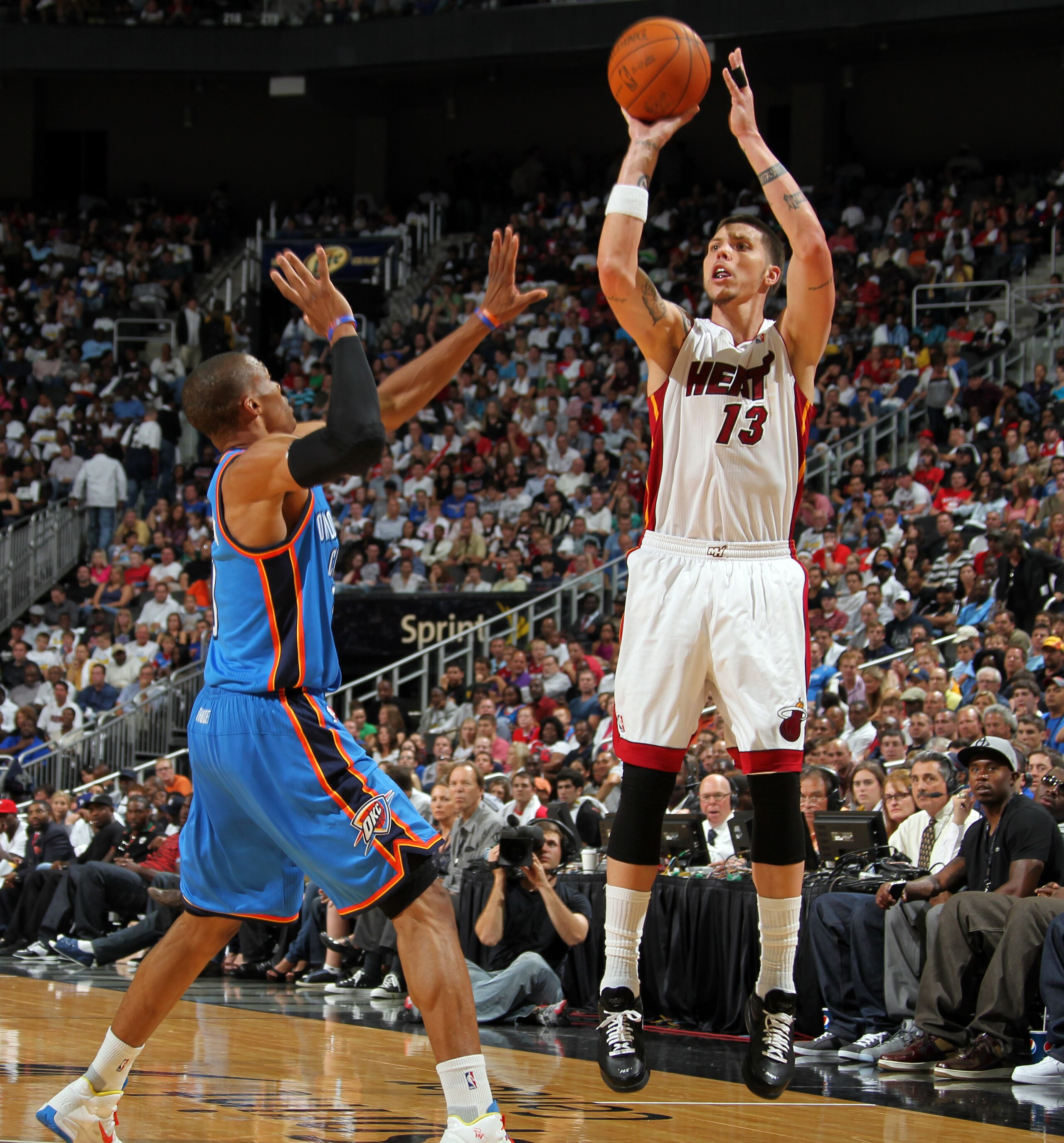KANSAS CITY, MO - OCTOBER 8: Mike Miller #13 of the Miami Heat shoots a jumpshot over Thabo Sefolosha #2 of the Oklahoma City Thunder on October 8, 2010 at the Sprint Center in Kansas City, Missouri.  NOTE TO USER: User expressly acknowledges and agrees t