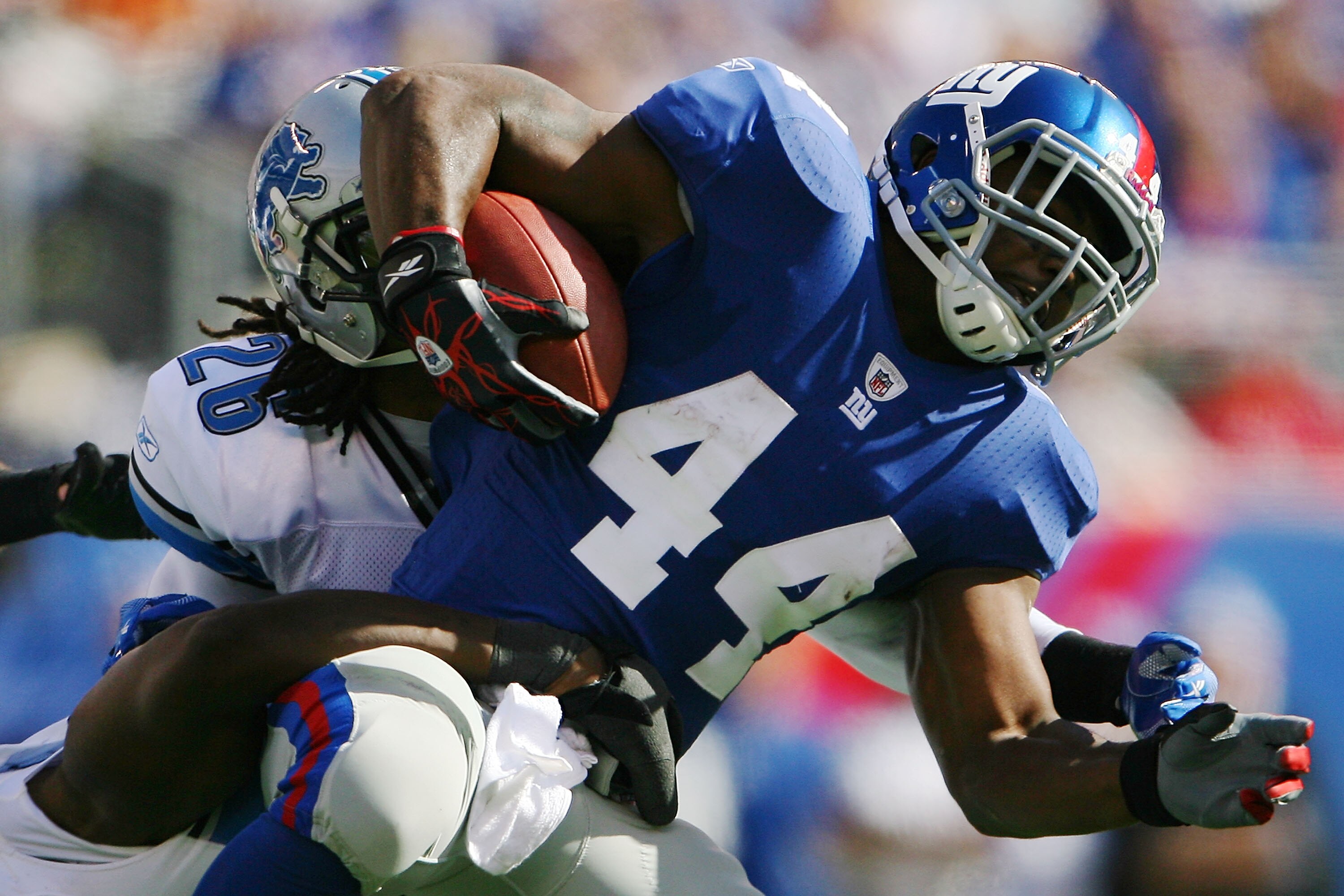 EAST RUTHERFORD, NJ - OCTOBER 17:  Louis Delmas #26 of the Detroit Lions tackles Ahmad Bradshaw #44 of the New York Giants at New Meadowlands Stadium on October 17, 2010 in East Rutherford, New Jersey.  (Photo by Andrew Burton/Getty Images)