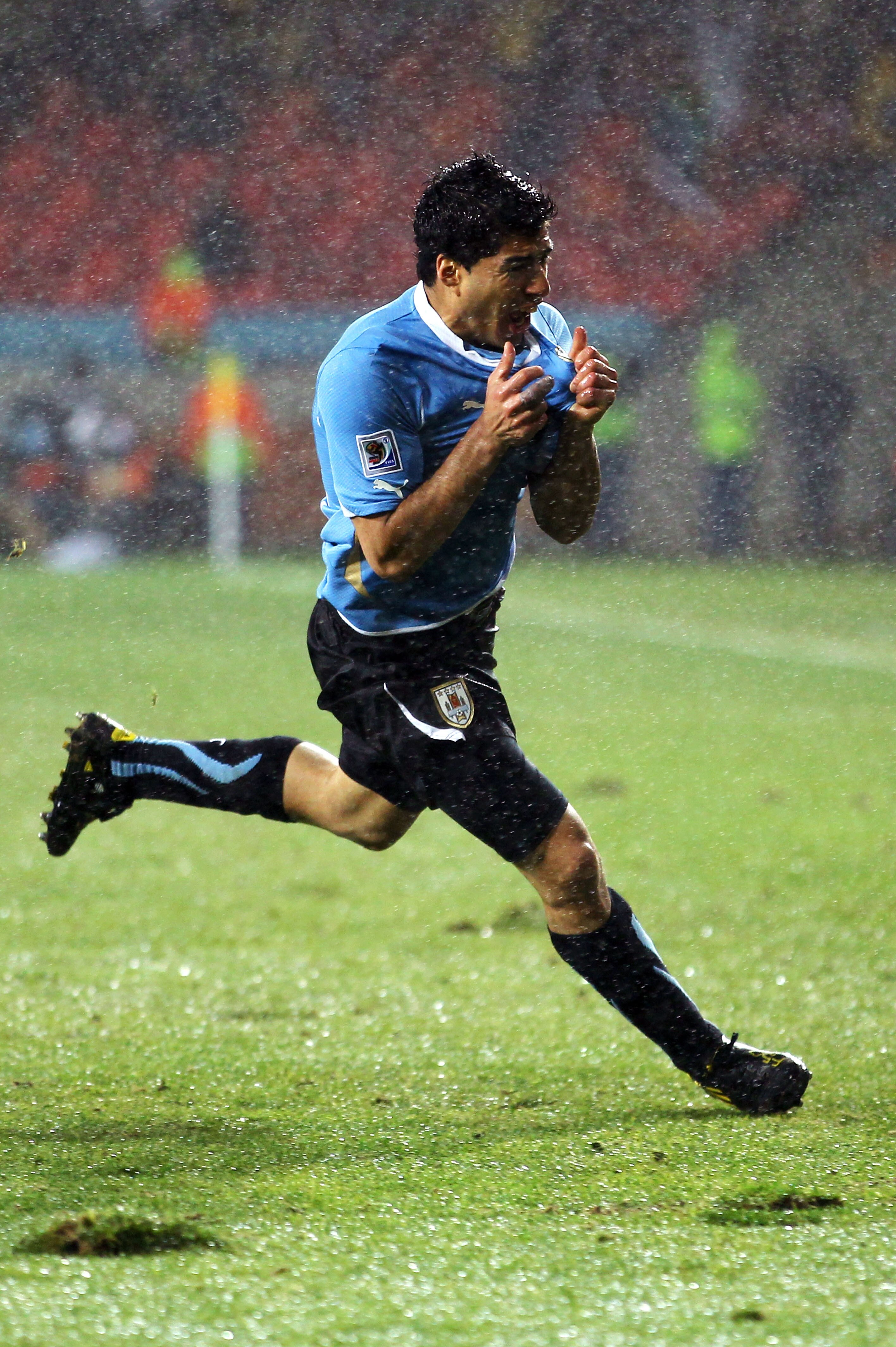PORT ELIZABETH, SOUTH AFRICA - JUNE 26:  Luis Suarez of Uruguay celebrates scoring his second goal during the 2010 FIFA World Cup South Africa Round of Sixteen match between Uruguay and South Korea at Nelson Mandela Bay Stadium on June 26, 2010 in Nelson