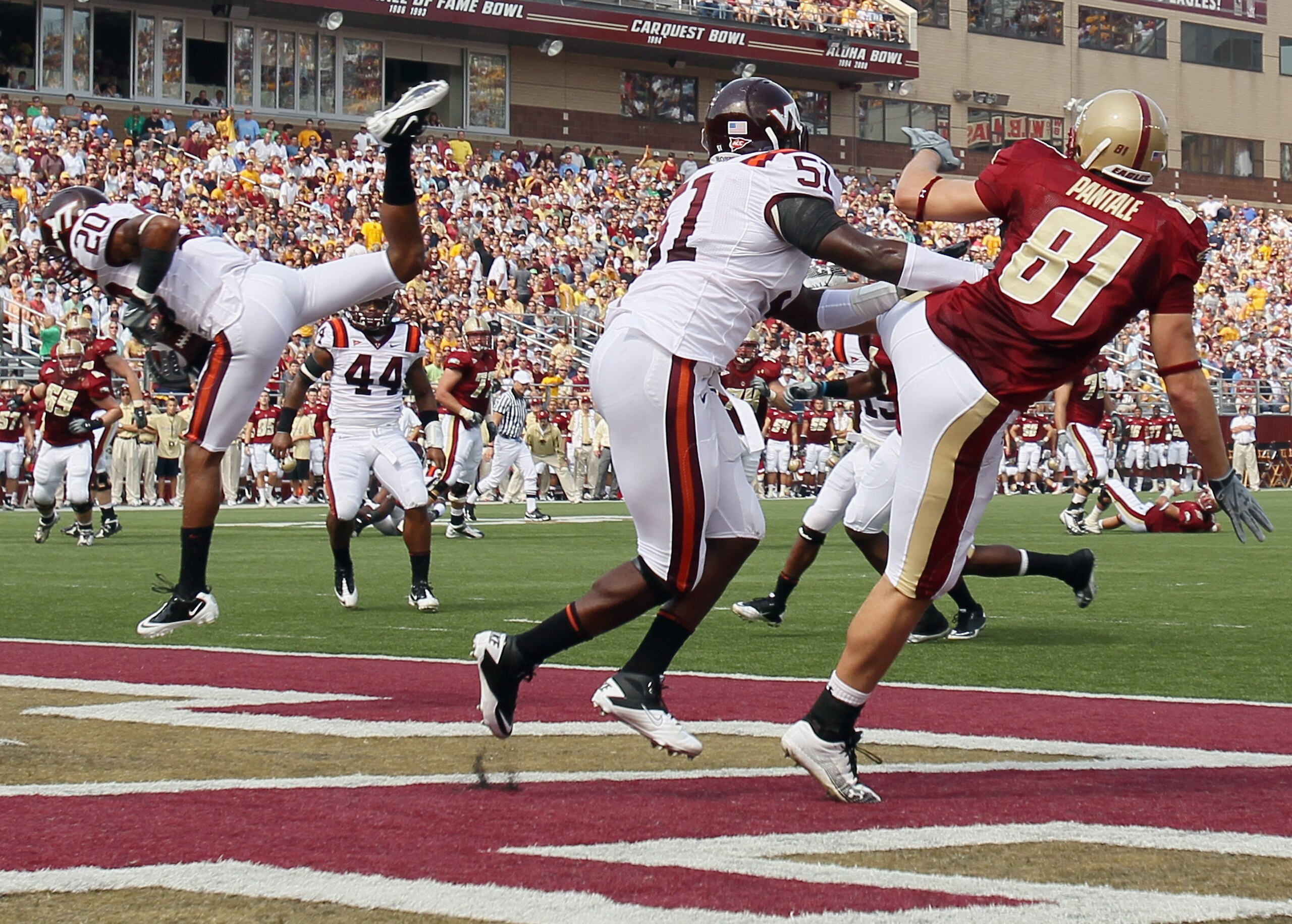CHESTNUT HILL, MA - SEPTEMBER 25:  Jayron Hosley #20 of the Virginia Tech Hokies intercepts a pass intended for Chris Pantale #81 of the Boston College Eagles as Bruce Taylor #51 of Virginia Tech defends on September 25, 2010 at Alumni Stadium in Chestnut