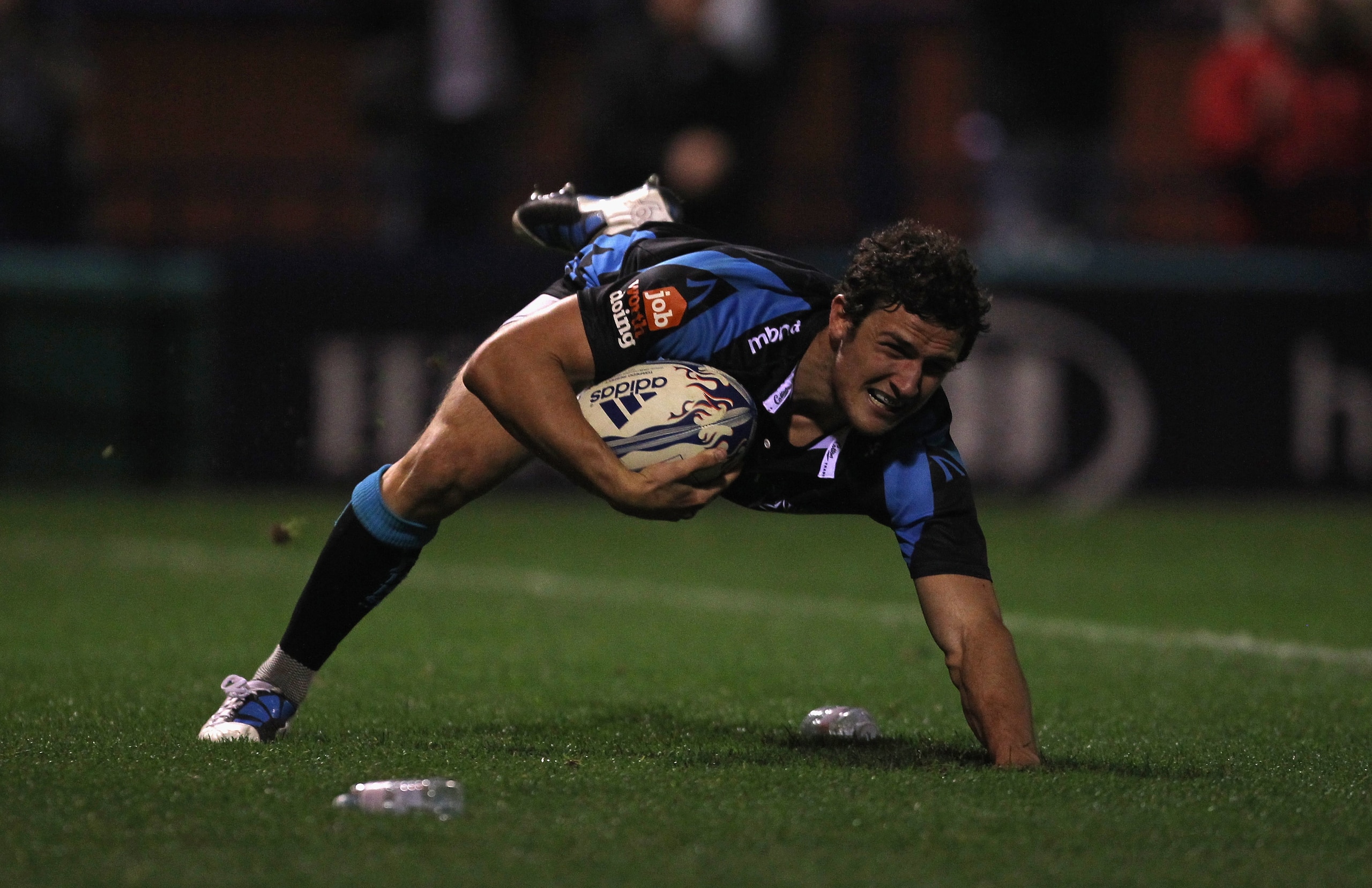 STOCKPORT, ENGLAND - OCTOBER 08:  Tom Brady of Sale Sharks dives over the line to score his second try during the Amlin Challenge Cup match between Sale Sharks and Cetransa El Salvador at Edgeley Park on October 8, 2010 in Stockport, England.  (Photo by A