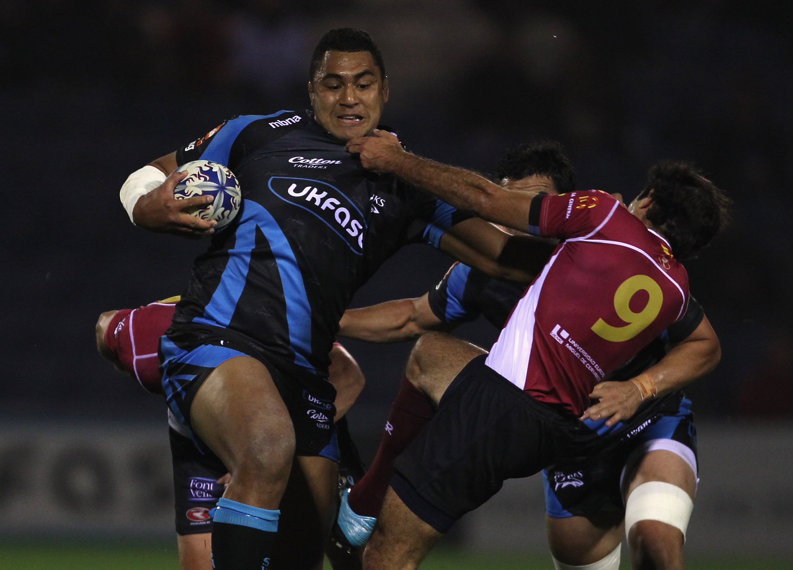 STOCKPORT, ENGLAND - OCTOBER 08:  Sisa Koyamaibole of Sale Sharks holds off a tackle from Pablo Feijoo of Cetransa El Salvador during the Amlin Challenge Cup match between Sale Sharks and Cetransa El Salvador at Edgeley Park on October 8, 2010 in Stockpor