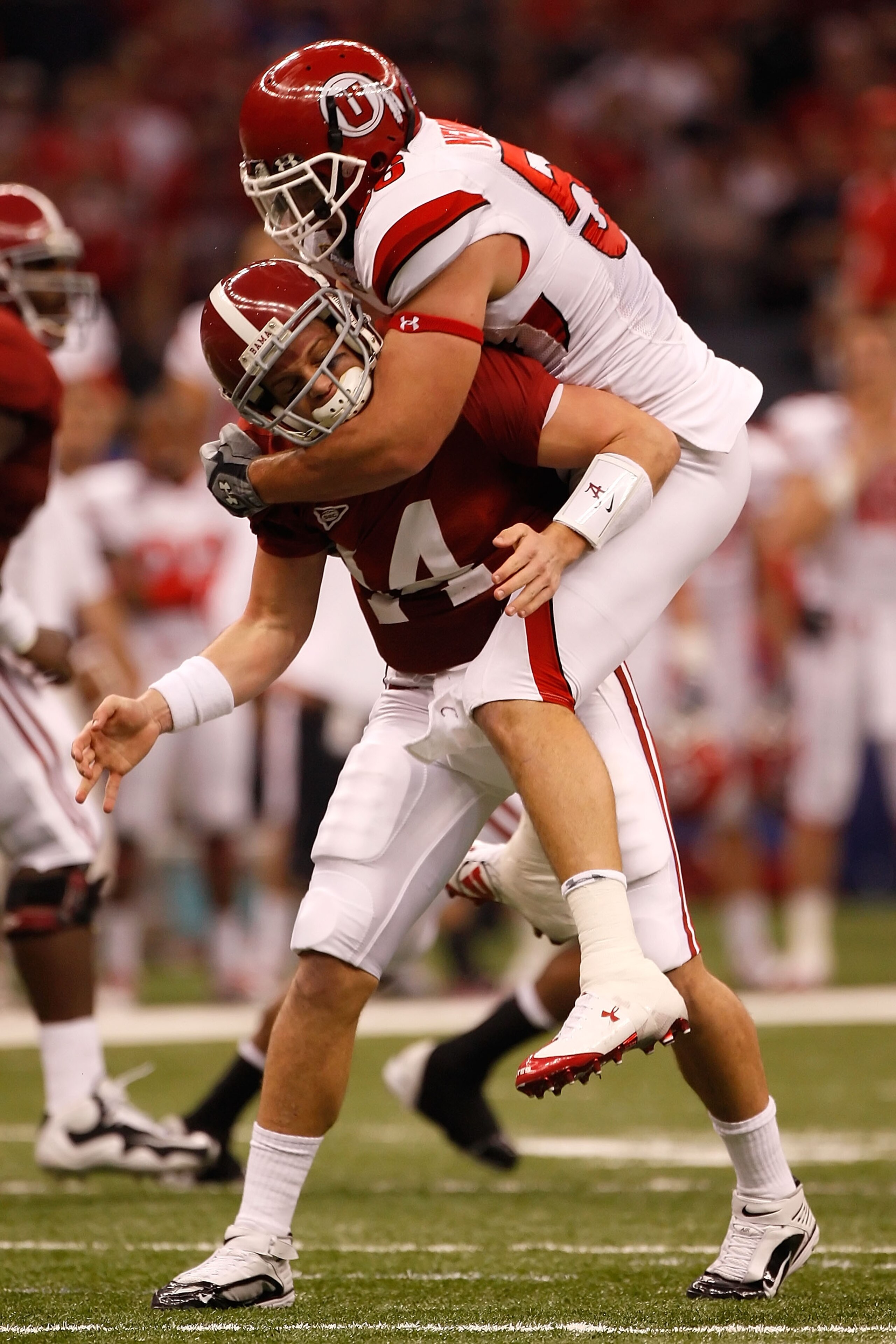 NEW ORLEANS - JANUARY 02:  Quarterback John Parker Wilson #14 of the Alabama Crimson Tide is hit as he throws by defensive tackle Greg Newman #56 of the Utah Utes in the first quarter during the 75th Allstate Sugar Bowl at the Louisiana Superdome on Janua