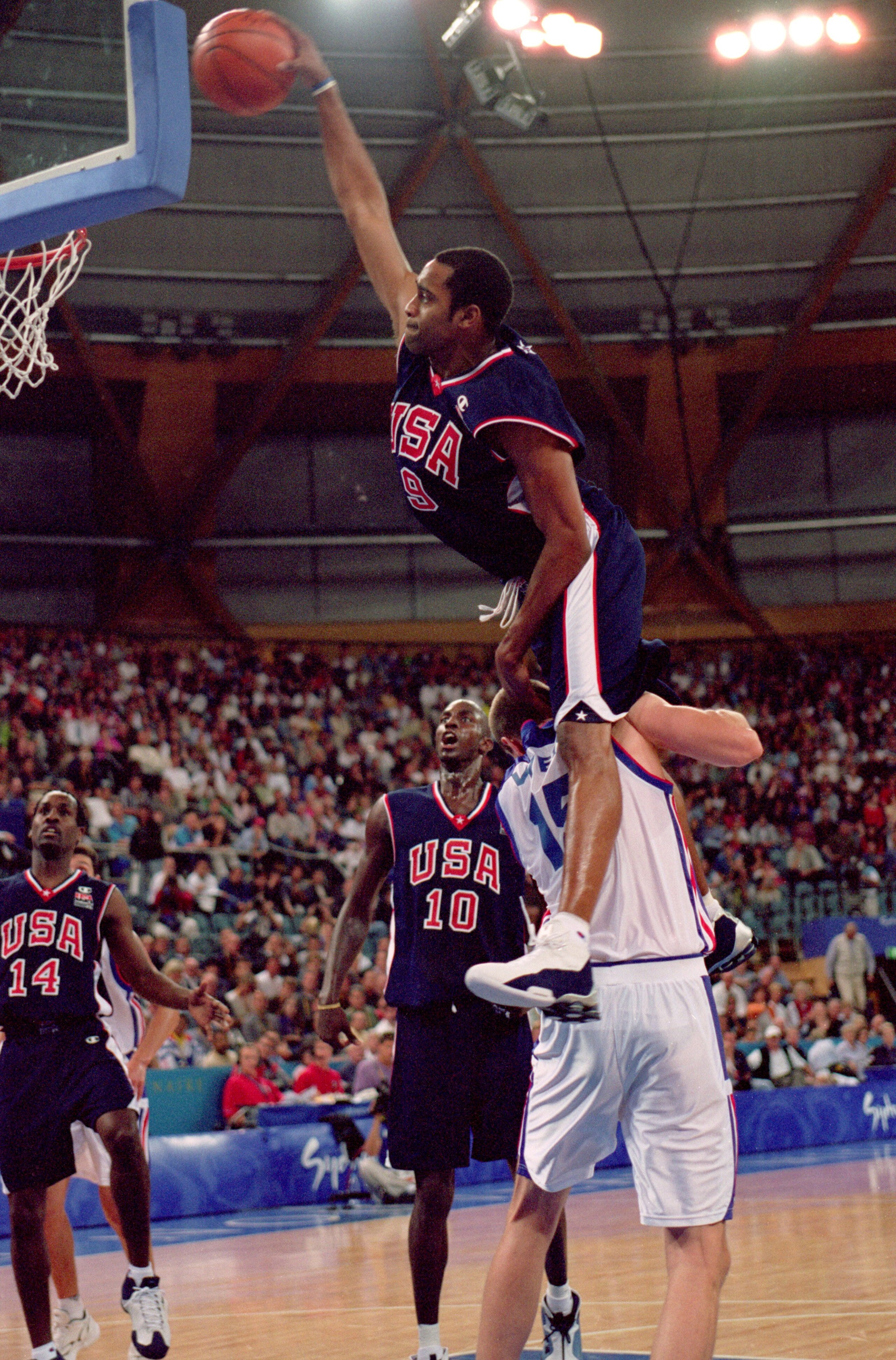 25 Sep 2000:  Vince Carter of the USA leaps over Frederic Weis of France to dunk during the Mens Basketball Preliminaries at the Dome in the Olympic Park on Day 10 of the Sydney 2000 Olympic Games in Sydney, Australia. \ Mandatory Credit: Darren McNamara/