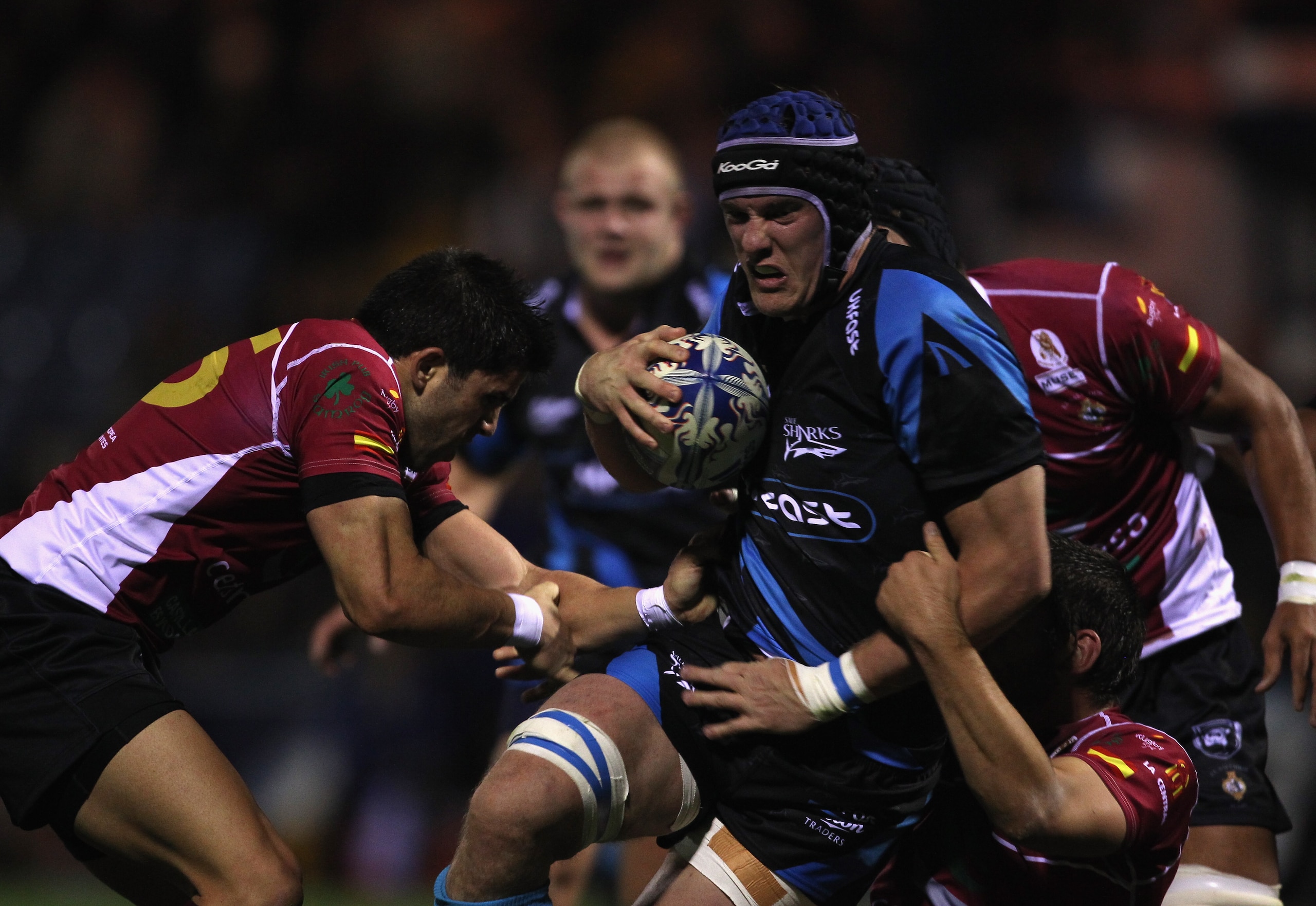 STOCKPORT, ENGLAND - OCTOBER 08:  Chris Jones of Sale Sharks is tackled by Luis Del Moral of Cetransa El Salvador during the Amlin Challenge Cup match between Sale Sharks and Cetransa El Salvador at Edgeley Park on October 8, 2010 in Stockport, England.