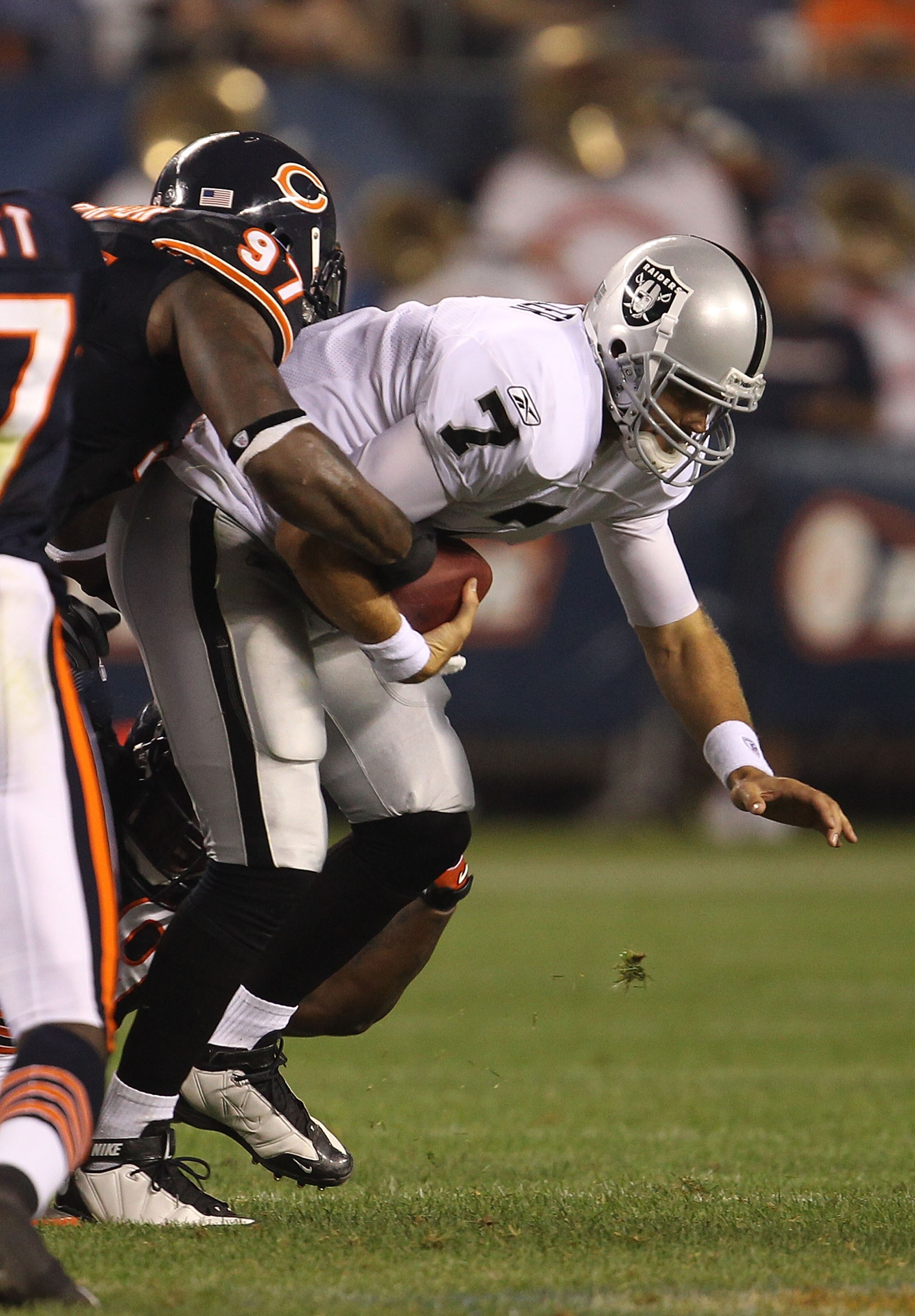 CHICAGO - AUGUST 21: Kyle Boller #7 of the Oakland Raiders is sacked by Mark Anderson #97 of the Chicago Bears during a preseason game at Soldier Field on August 21, 2010 in Chicago, Illinois. The Raiders defeated the Bears 32-17. (Photo by Jonathan Danie