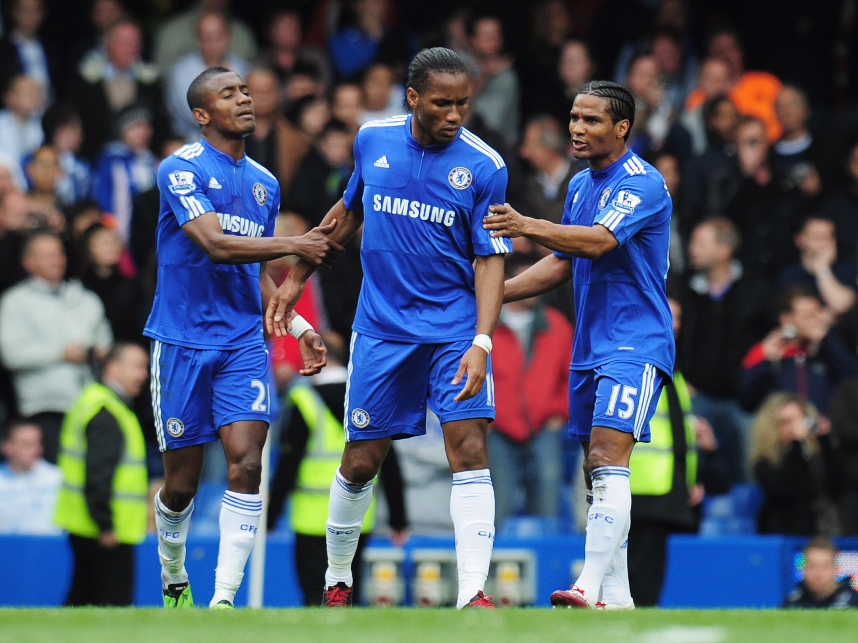 LONDON, ENGLAND - MAY 09:  Didier Drogba of Chelsea (C) is restrained by Florent Malouda (L) and Salomon Kalou (R) as Frank Lampard prepares to take a penalty during the Barclays Premier League match between Chelsea and Wigan Athletic at Stamford Bridge o