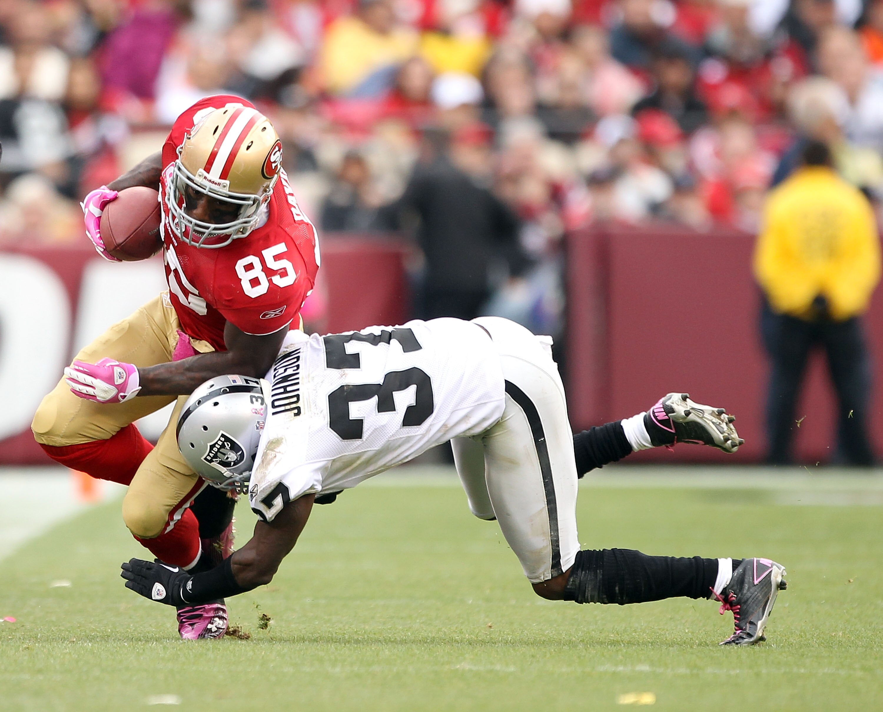 SAN FRANCISCO - OCTOBER 17:  Vernon Davis #85 of the San Francisco 49ers is tackled by Chris Johnson #37 of the Oakland Raiders at Candlestick Park on October 17, 2010 in San Francisco, California.  (Photo by Ezra Shaw/Getty Images)