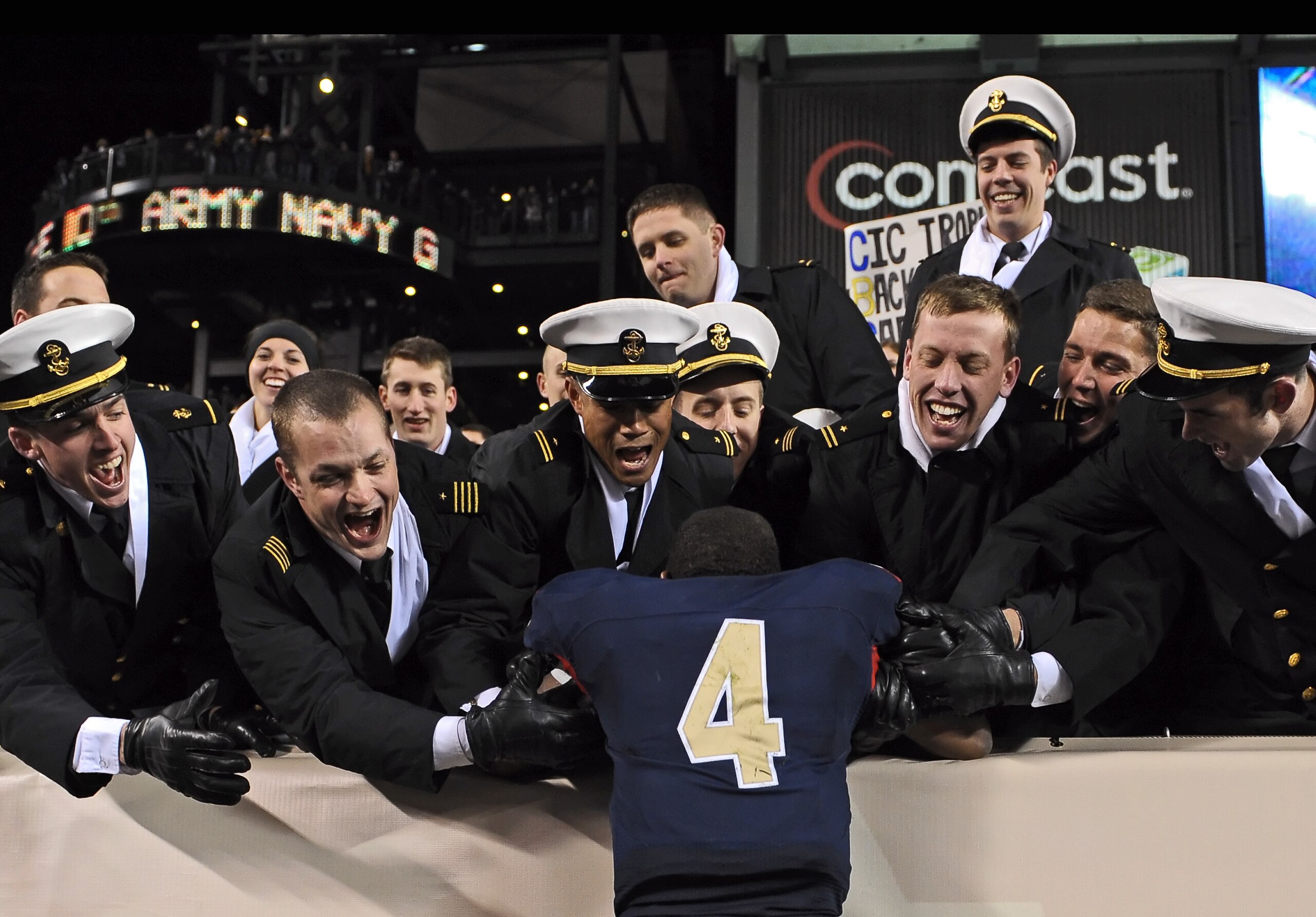PHILADELPHIA - DECEMBER 12: Quarterback Ricky Dobbs #4 of the Navy Midshipmen, and game MVP, jumps into the crowd after their 17-3 victory over the Army Black Knights on December 12, 2009 at Lincoln Financial Field in Philadelphia, Pennsylvania. (Photo by
