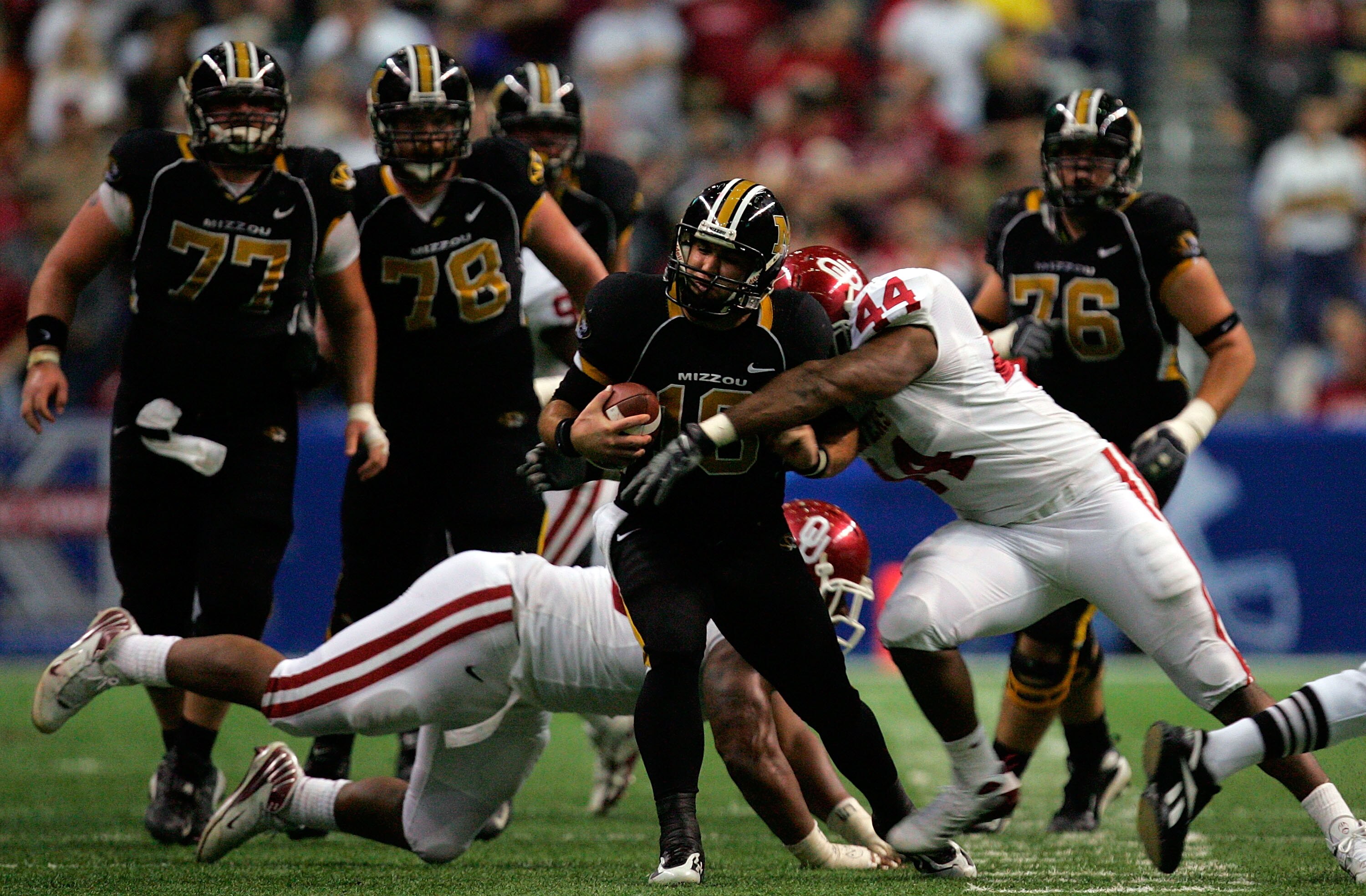 SAN ANTONIO - DECEMBER 1:  Quarterback Chase Daniel #10 of the Missouri Tigers is tackled by Jeremy Beal #44 of the Oklahoma Sooners during the Big 12 Championship at the Alamodome December 1, 2007 in San Antonio, Texas.  (Photo by Ronald Martinez/Getty I