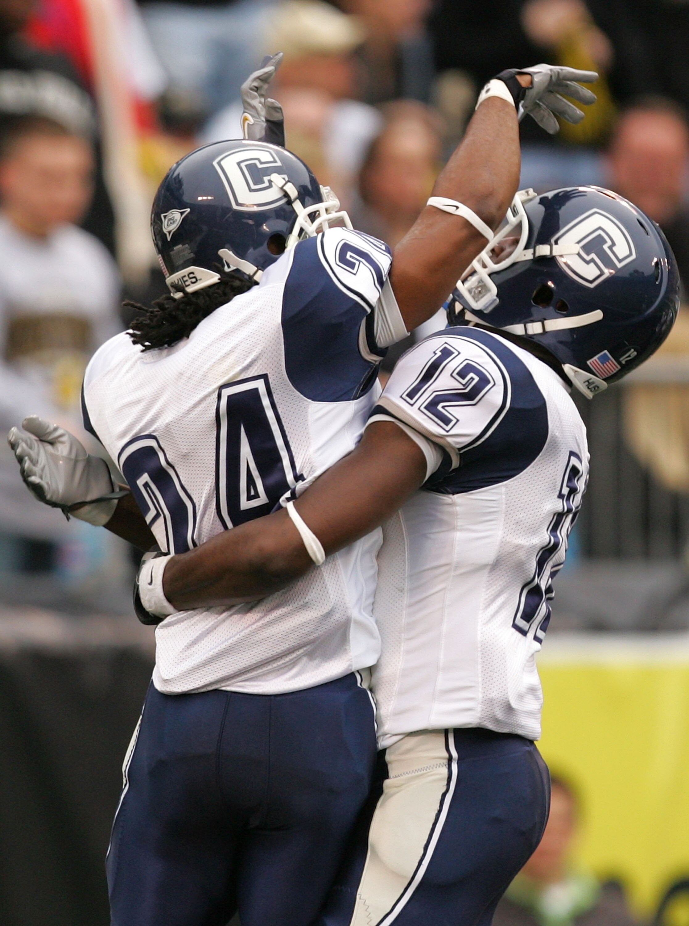 CHARLOTTE, NC - DECEMBER 29:  Teammates Larry Taylor #24 and Marcus Easley #12 of the Connecticut Huskies celebrate after Taylors touchdown against the Wake Forest Demon Deacons at Bank of America Stadium on December 29, 2007 in Charlotte, North Carolina.