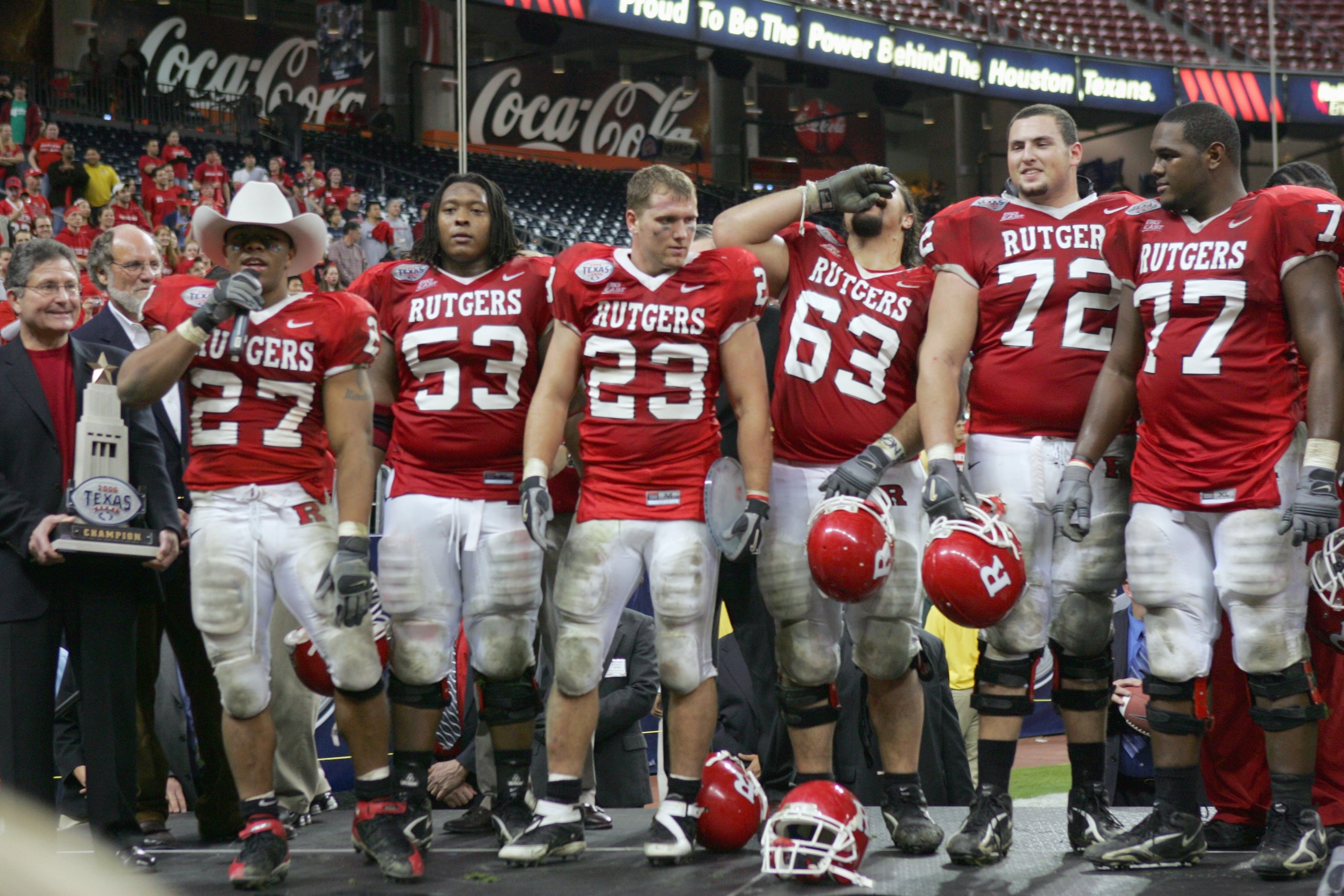 HOUSTON - DECEMBER 28:  The Rutgers Scarlet Knights stand to recieve the Texas Bowl trophy after the game against the Kansas State Wildcats on December 28, 2006 at Reliant Stadium in Houston Texas. Rutgers won 37-10.  (Photo by Stephen Dunn/Getty Images)