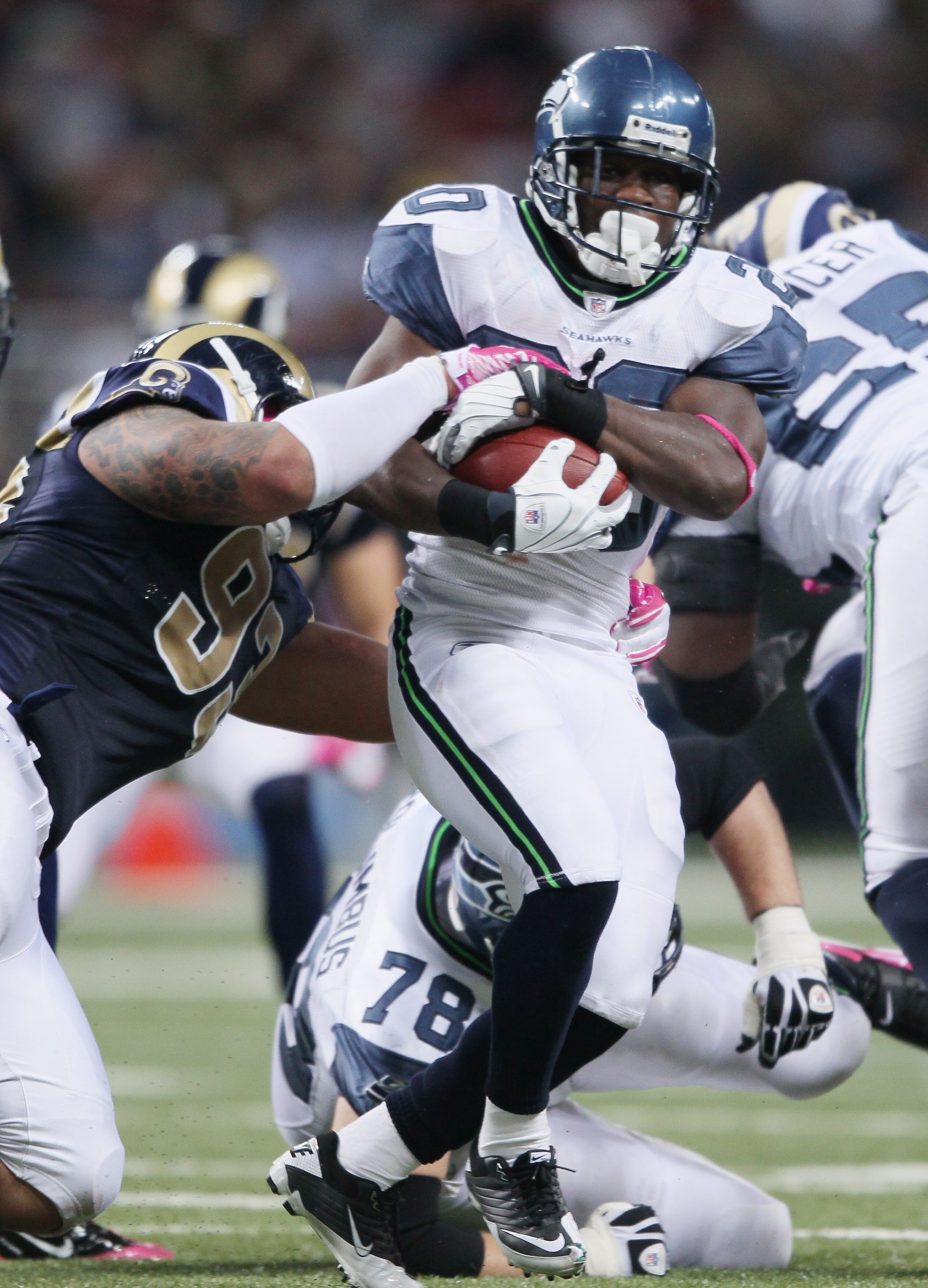 ST. LOUIS - OCTOBER 03:   Justin Forsett #20 of the Seattle Seahawks carries the ball as Jermelle Cudjo #93 of the St. Louis Rams defends on October 3, 2010 at Edward Jones Dome in St. Louis, Missouri.  (Photo by Elsa/Getty Images)