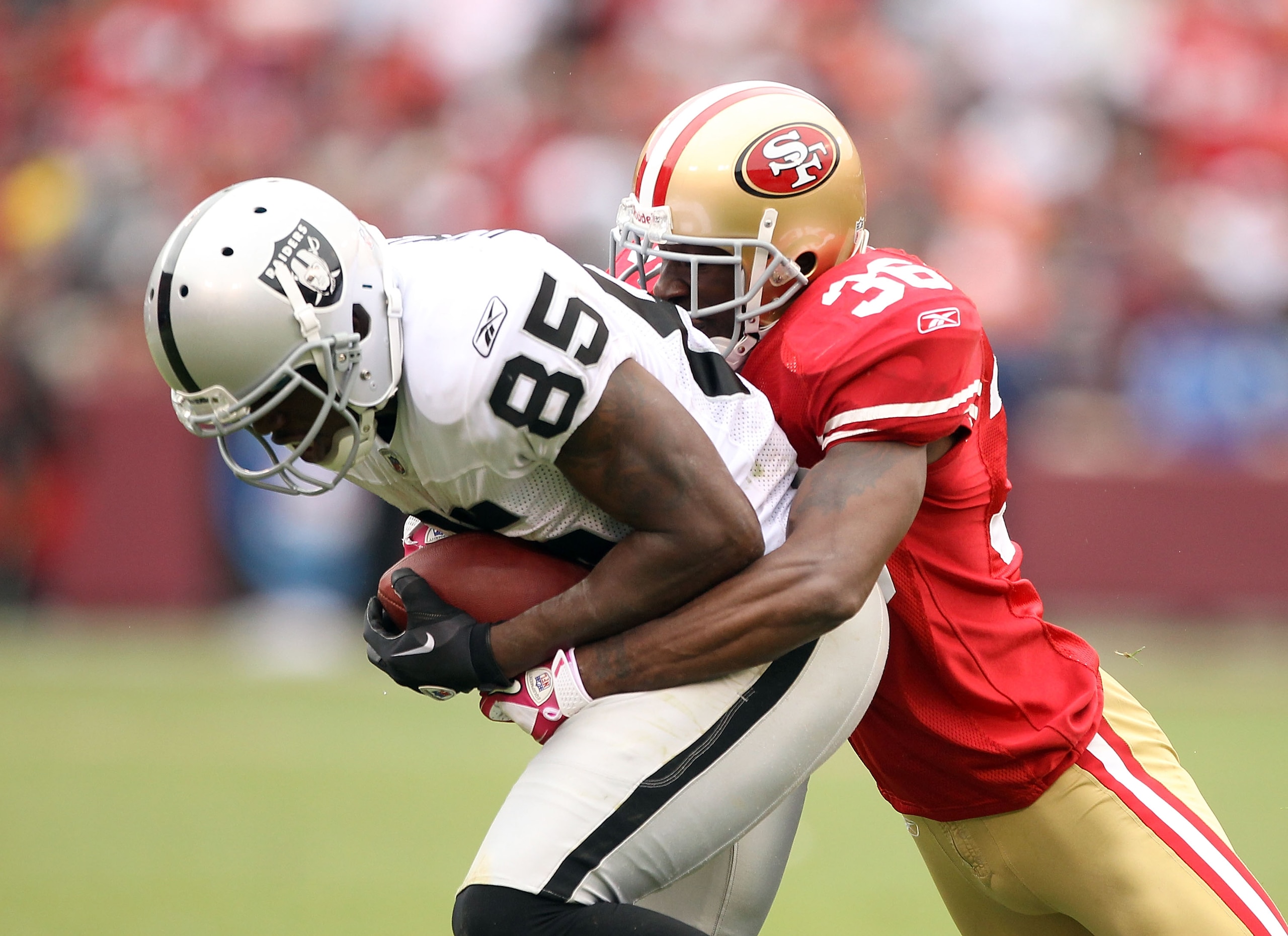 SAN FRANCISCO - OCTOBER 17:  Darrius Heyward-Bey #85 of the Oakland Raiders is tackled by Dashon Goldson #38 of the San Francisco 49ers at Candlestick Park on October 17, 2010 in San Francisco, California.  (Photo by Ezra Shaw/Getty Images)