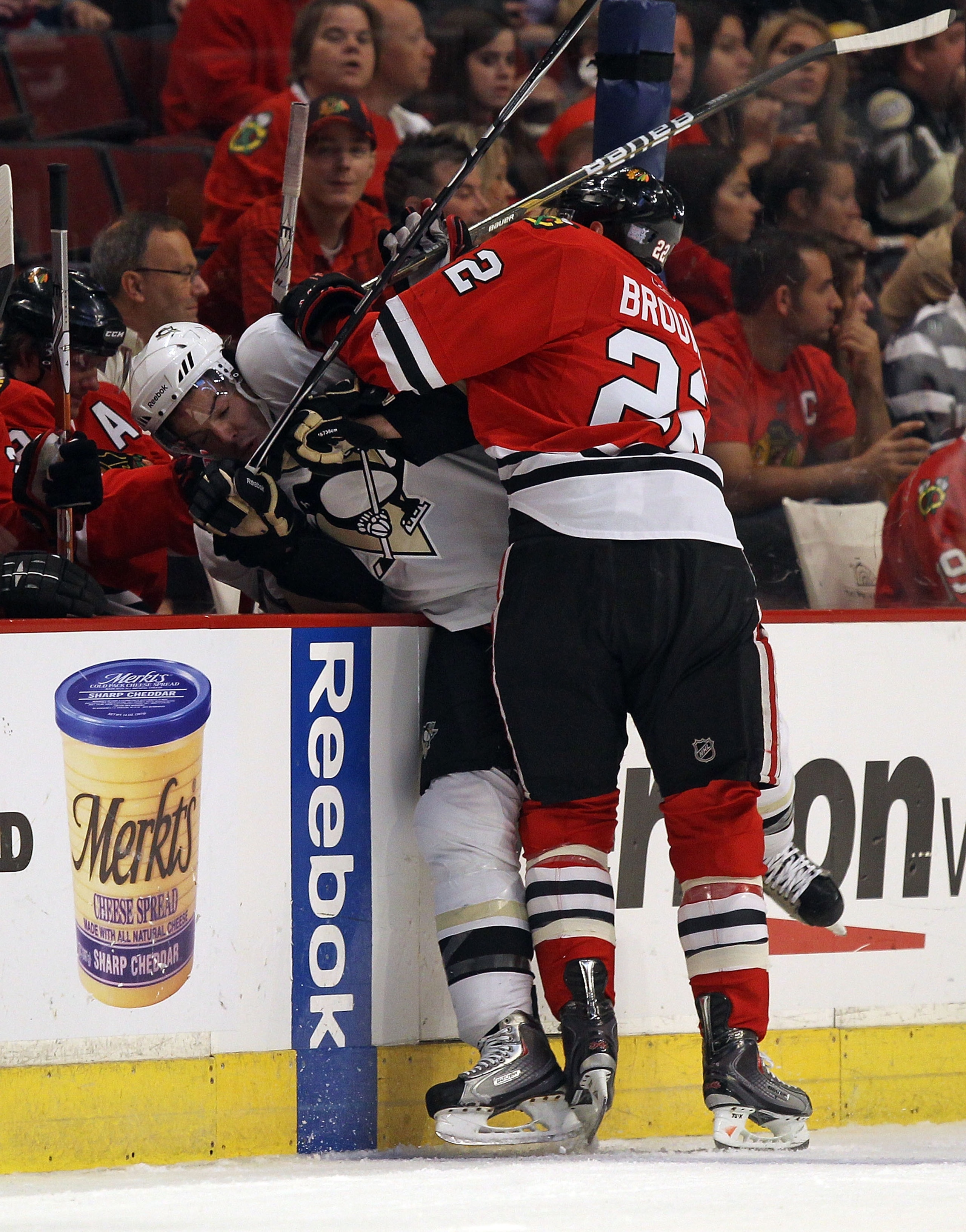 CHICAGO - OCTOBER 01: Troy Brouwer #22 of the Chicago Blackhawks checks Simon Despres #47 of the Pittsburgh Penguins into the Blackhawk bench during a pre-season game at the United Center on October 1, 2010 in Chicago, Illinois. (Photo by Jonathan Daniel/