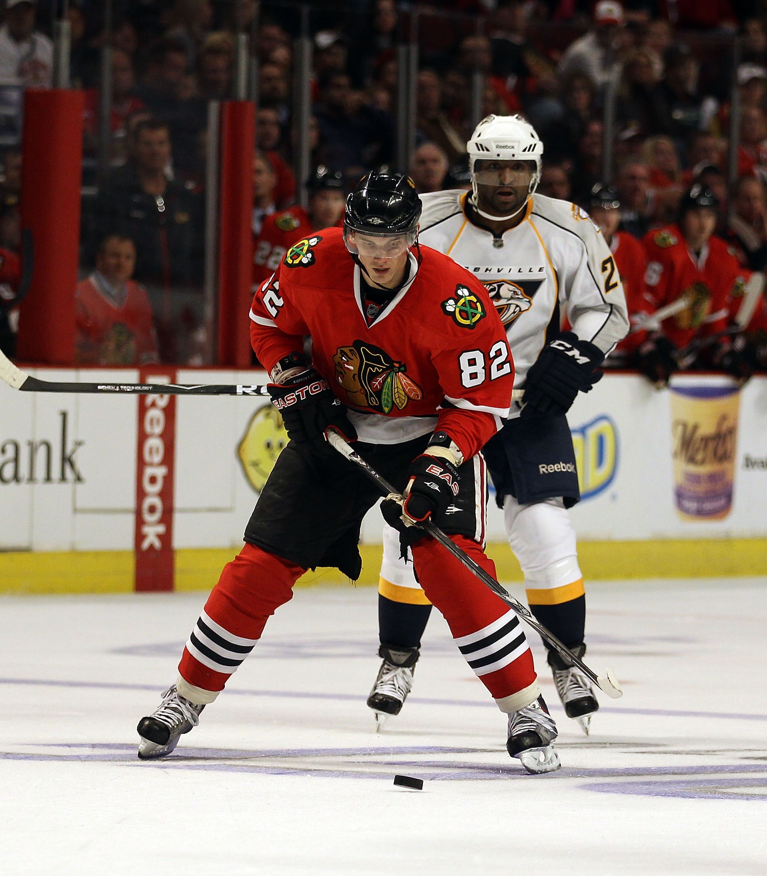 CHICAGO - OCTOBER 13: Tomas Kopecky #82 of the Chicago Blackhawks skates up the ice in front of Joel Ward #29 of the Nashville Predators at the United Center on October 13, 2010 in Chicago, Illinois. The Predators defeated the Blackhawks 3-2.  (Photo by J