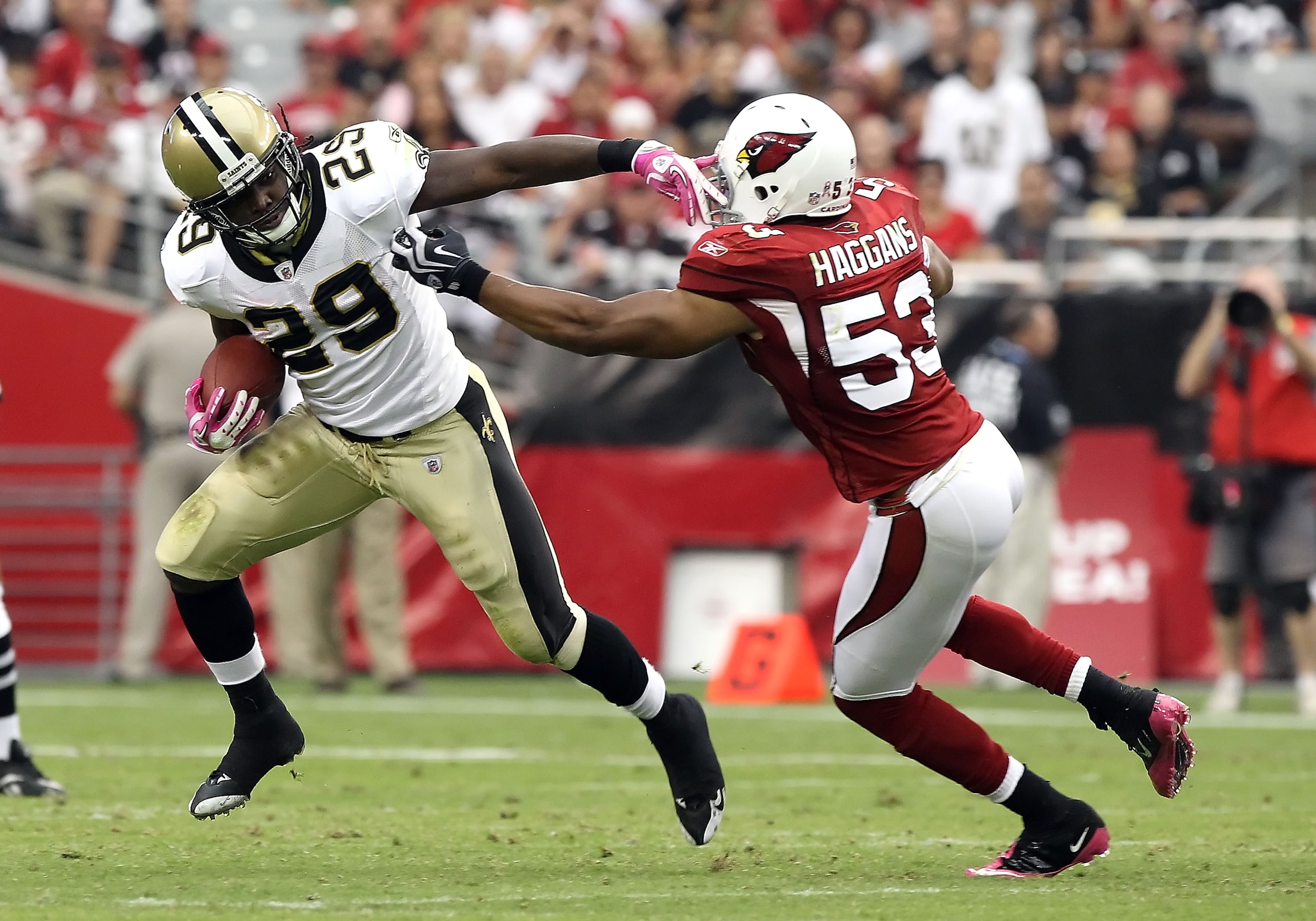 GLENDALE, AZ - OCTOBER 10:  Runningback Chris Ivory #29 of the New Orleans Saints runs with the football past Clark Haggans #53 of the Arizona Cardinals during the NFL game at the University of Phoenix Stadium on October 10, 2010 in Glendale, Arizona.  Th