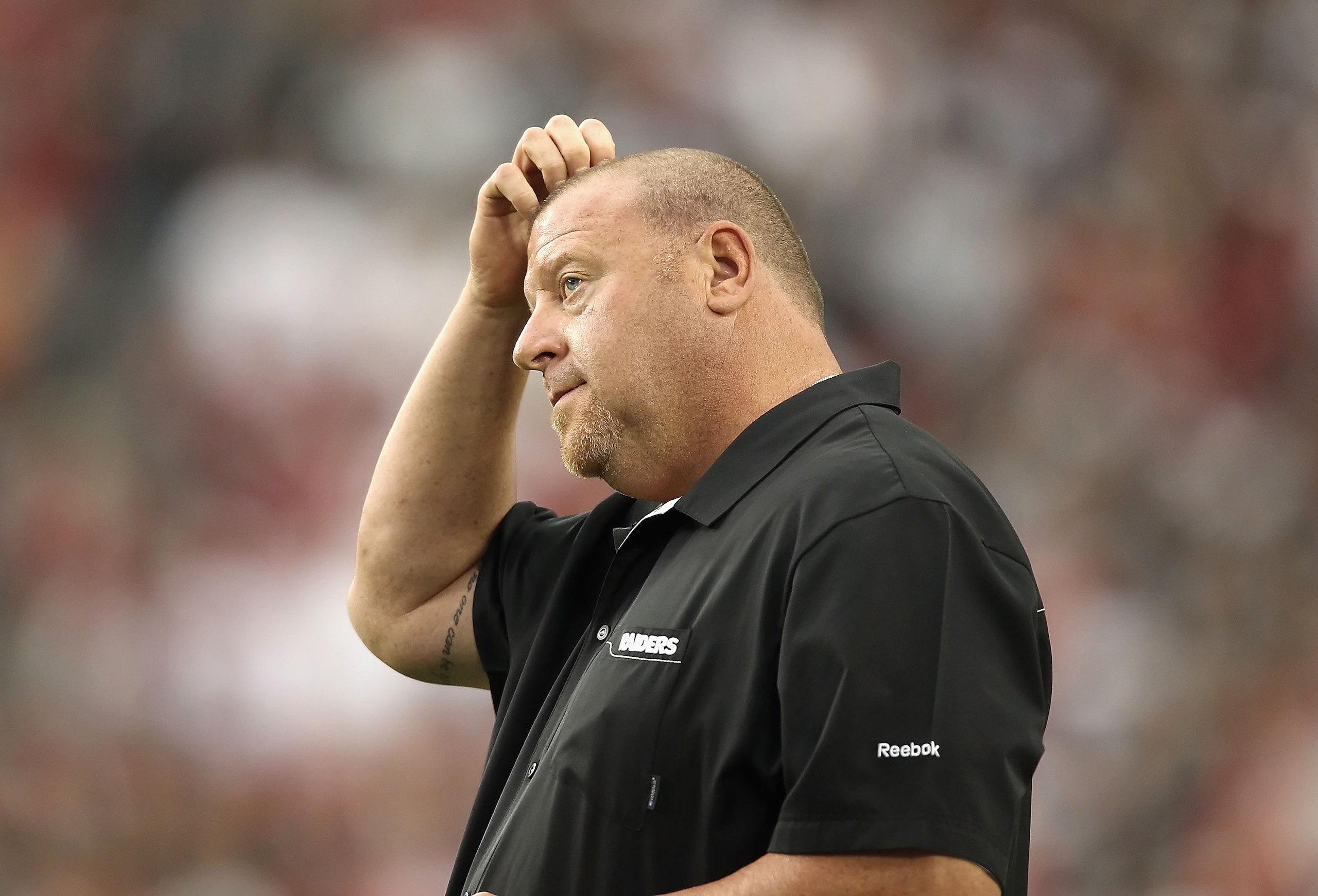 GLENDALE, AZ - SEPTEMBER 26:  Head coach Tom Cable of the Oakland Raiders stands on the sidelines during the NFL game against the Arizona Cardinals at the University of Phoenix Stadium on September 26, 2010 in Glendale, Arizona.  The Cardinals defeated th