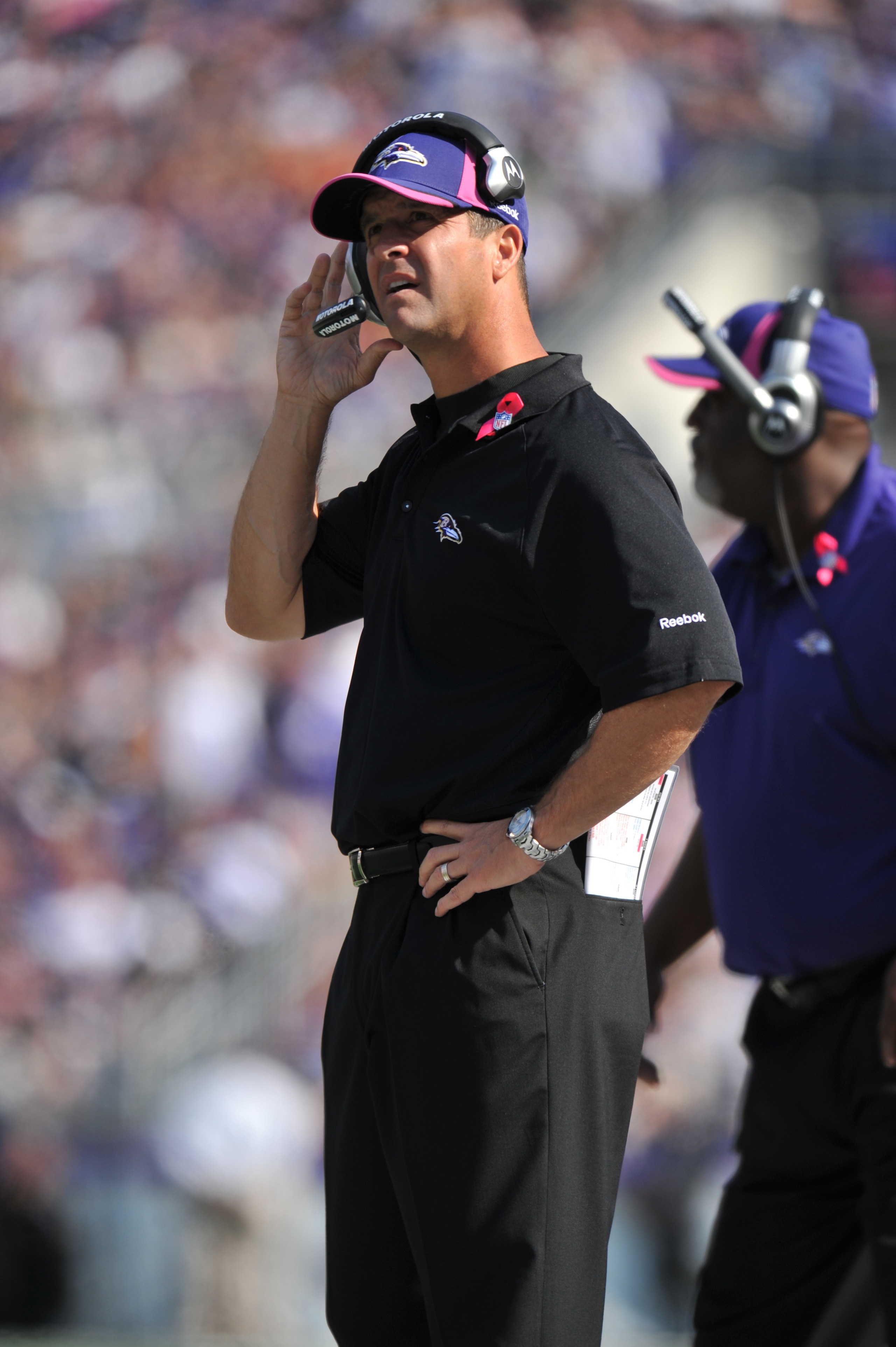 BALTIMORE, MD - OCTOBER 10: Head coach John Harbaugh of the Baltimore Ravens coaches against the Denver Broncos at M&T Bank Stadium on October 10, 2010 in Baltimore, Maryland. Players wore pink in recognition of Breast Cancer Awareness Month. The Ravens d