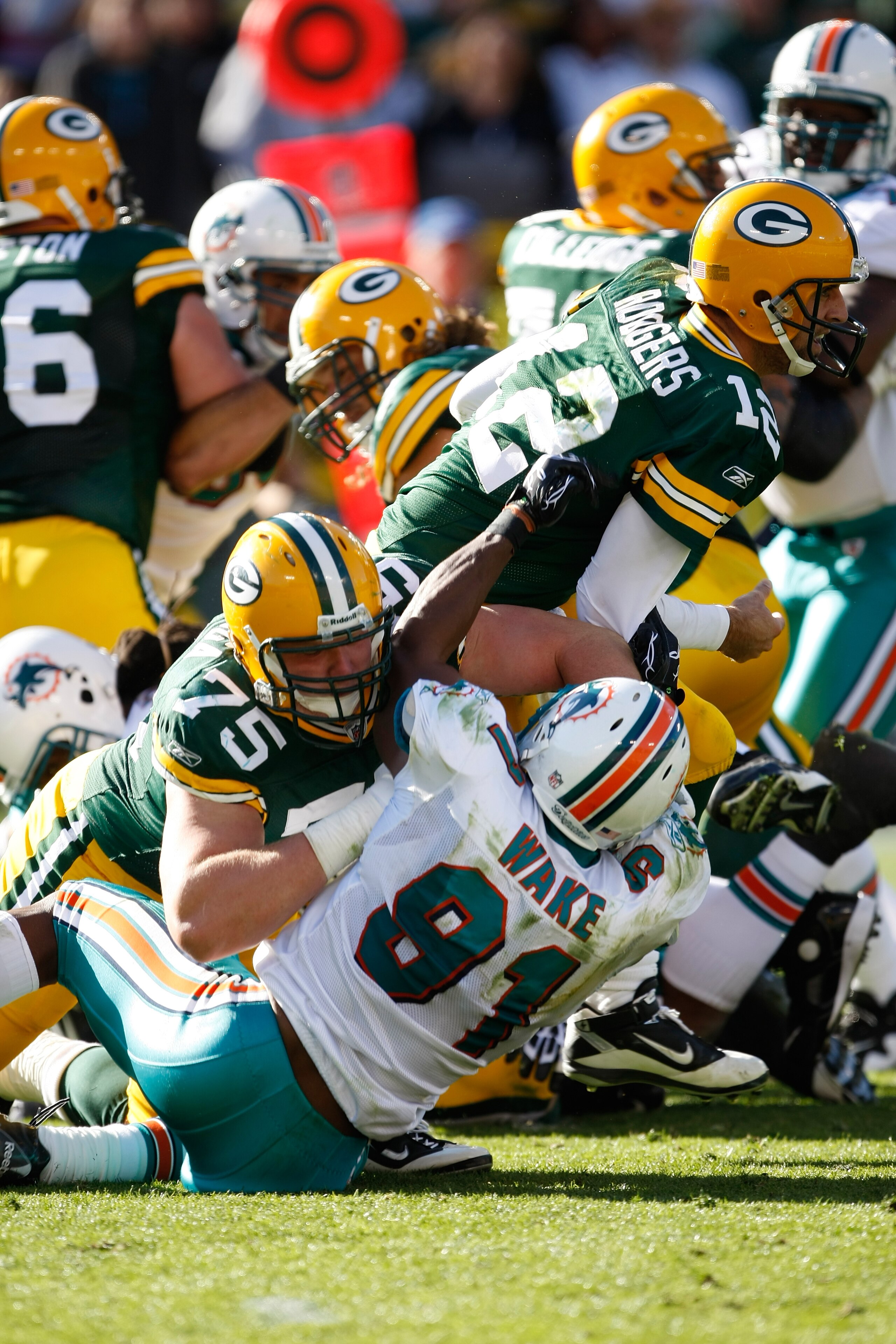 GREEN BAY, WI - OCTOBER 17: Aaron Rogers #12 of the Green Bay Packers runs against the Miami Dolphins at Lambeau Field on October 17, 2010 in Green Bay, Wisconsin. The Dolphins defeated the Packers 23-20 in overtime. (Photo by Scott Boehm/Getty Images)