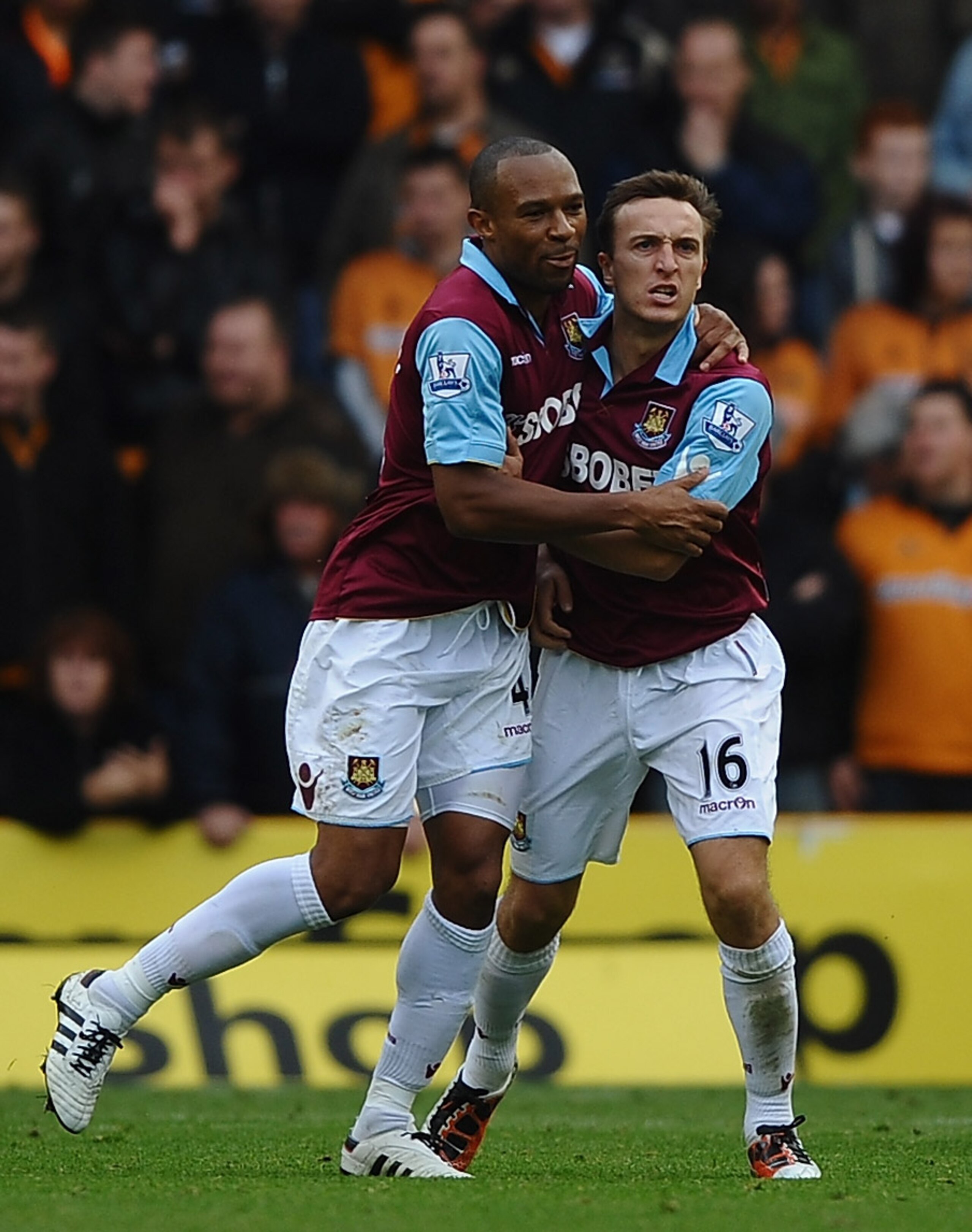 WOLVERHAMPTON, ENGLAND - OCTOBER 16: Mark Noble of West Ham is congratulated on scoring the equaliser by Danny Gabbidon during the Barclays Premier League match between Wolverhampton Wanderers and West Ham United at Molineux on October 16, 2010 in Wolverh