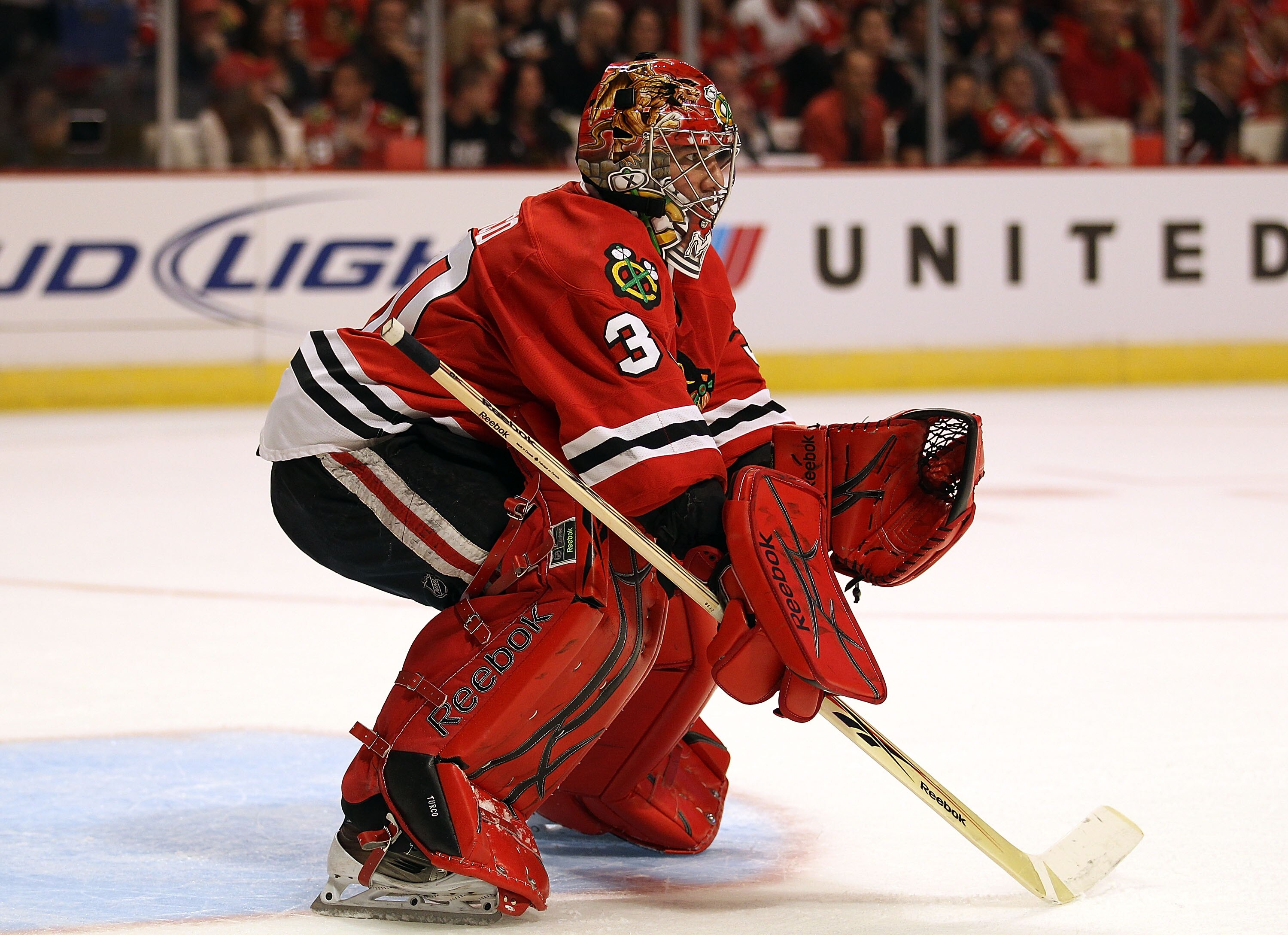 CHICAGO - OCTOBER 09: Marty Turco #30 of the Chicago Blackhawks keeps his eyes on the action against the Detroit Red Wings during the Blackhawks season home opening game at the United Center on October 9, 2010 in Chicago, Illinois. The Red Wings defeated