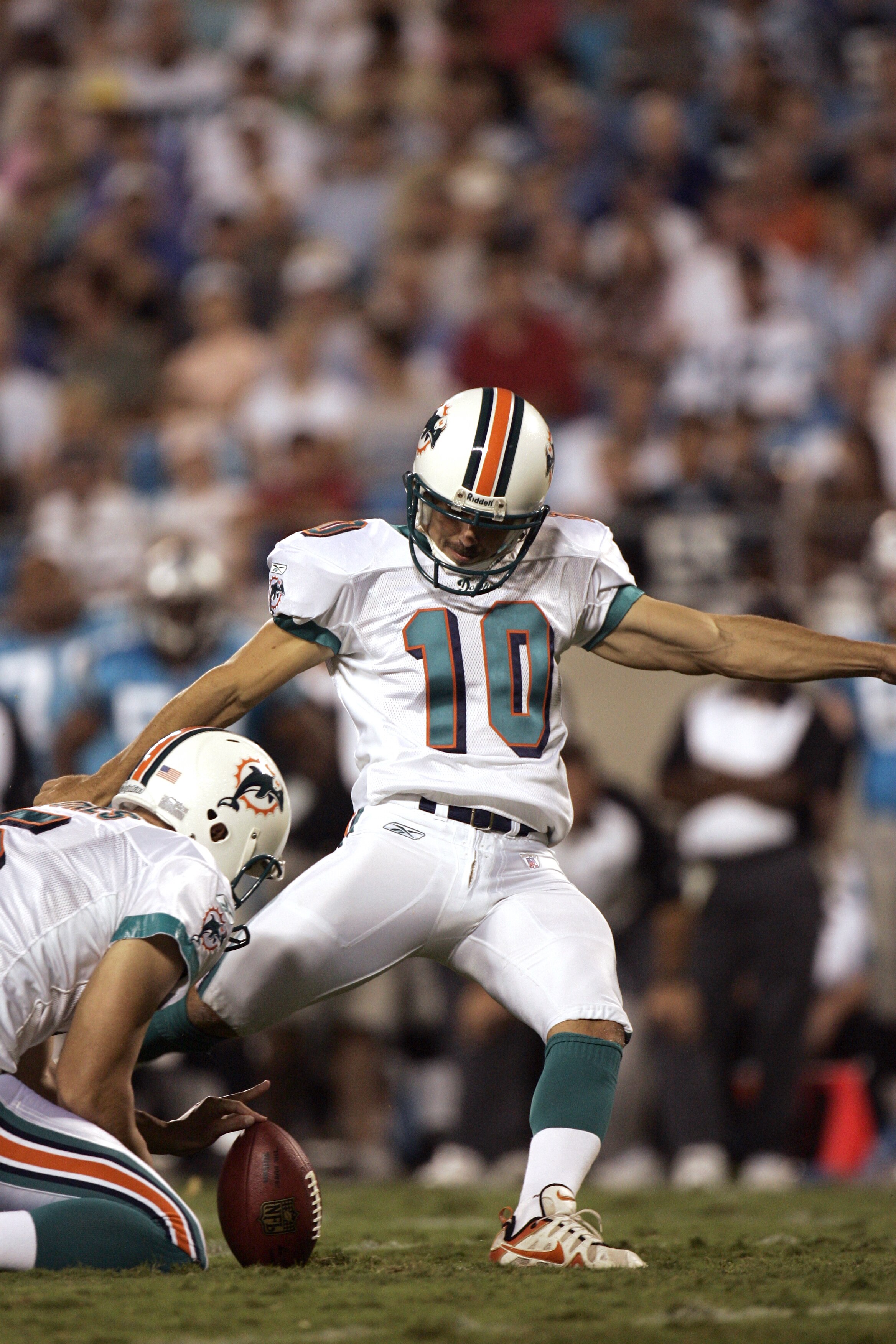 CHARLOTTE, NC - AUGUST 24:  Kicker Olindo Mare #10 of the Miami Dolphins attempts to score, as punter Donnie Jones #5 holds the ball, during the preseason game against the Carolina Panthers at Bank of America Stadium in Charlotte, North Carolina, on Augus