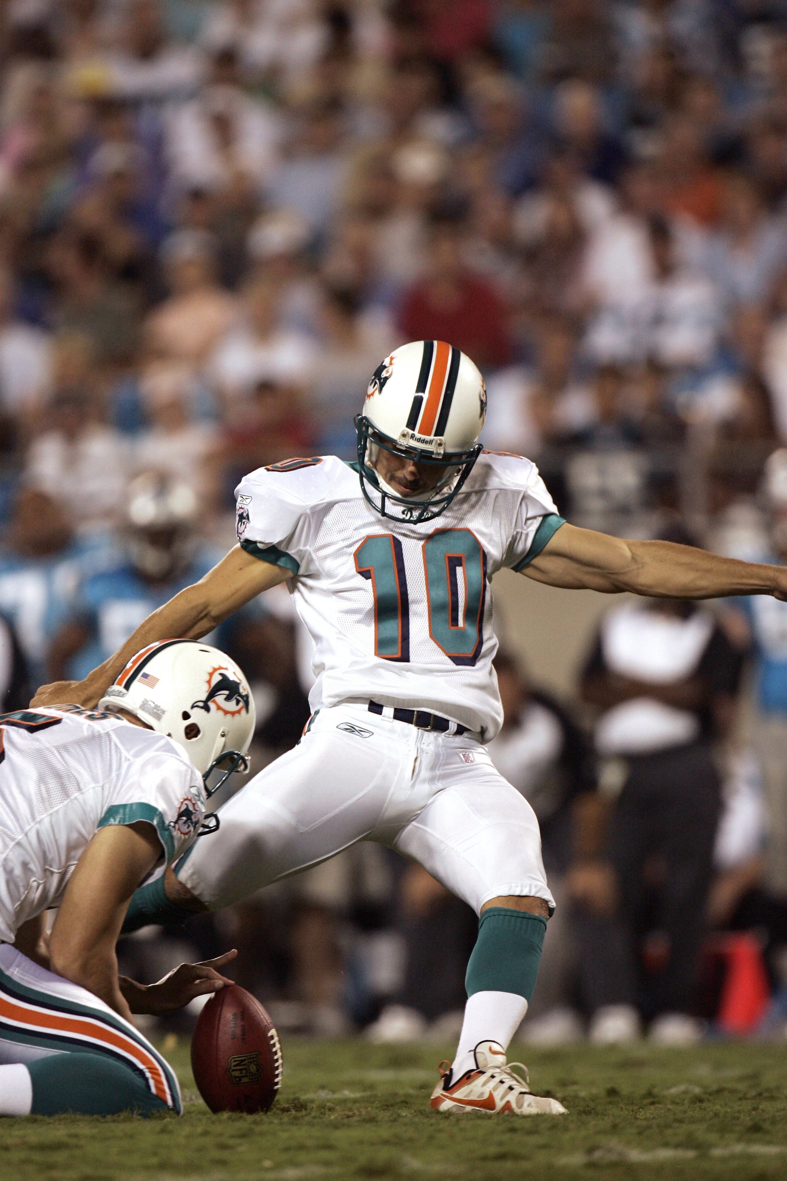 CHARLOTTE, NC - AUGUST 24:  Kicker Olindo Mare #10 of the Miami Dolphins attempts to score, as punter Donnie Jones #5 holds the ball, during the preseason game against the Carolina Panthers at Bank of America Stadium in Charlotte, North Carolina, on Augus