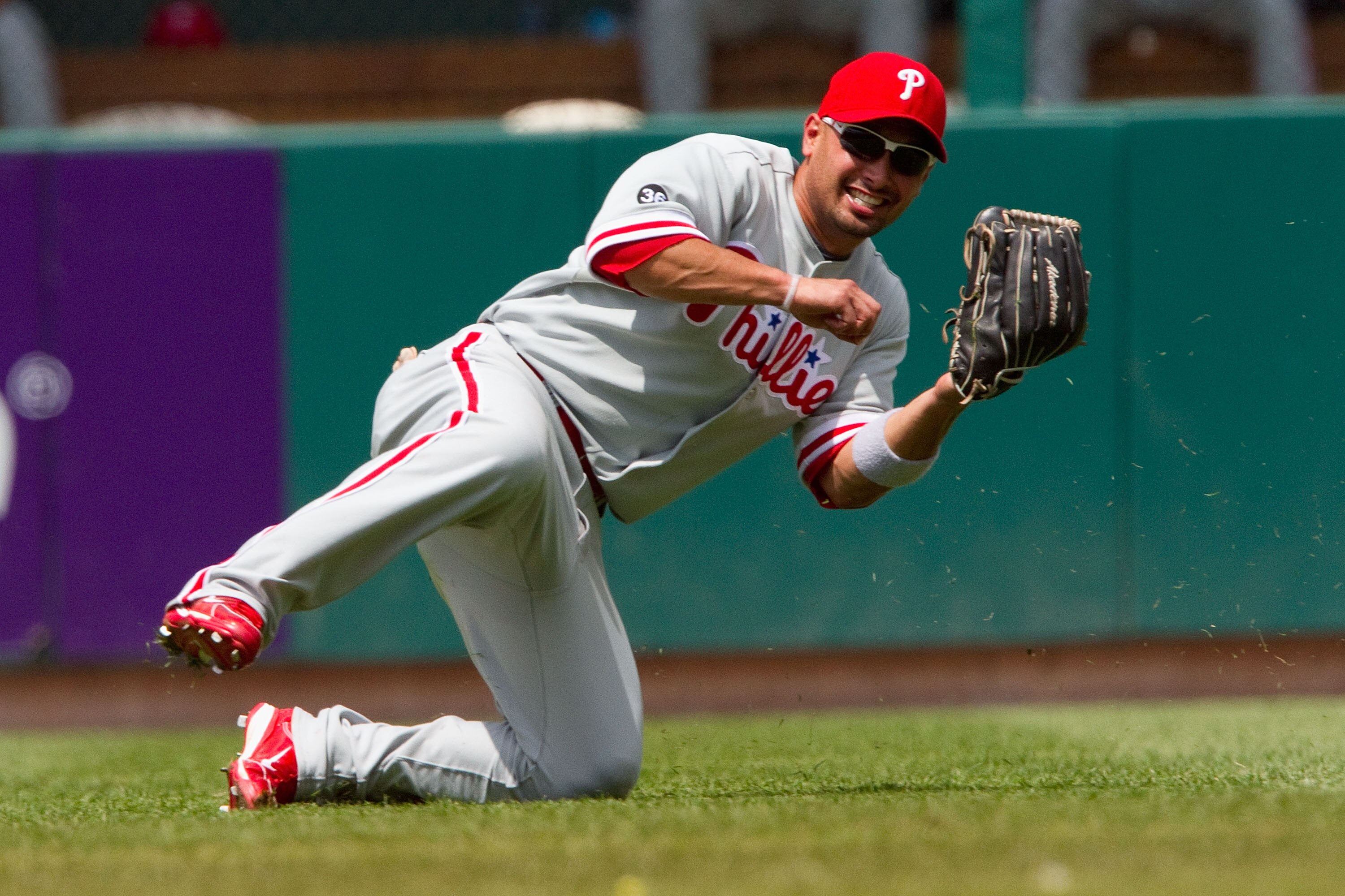 ST. LOUIS - JULY 22: Shane Victorino #8 of the Philadelphia Phillies makes a catch against the St. Louis Cardinals at Busch Stadium on July 22, 2010 in St. Louis, Missouri. The Phillies defeated the Cardinals 2-0.  (Photo by Dilip Vishwanat/Getty Images)