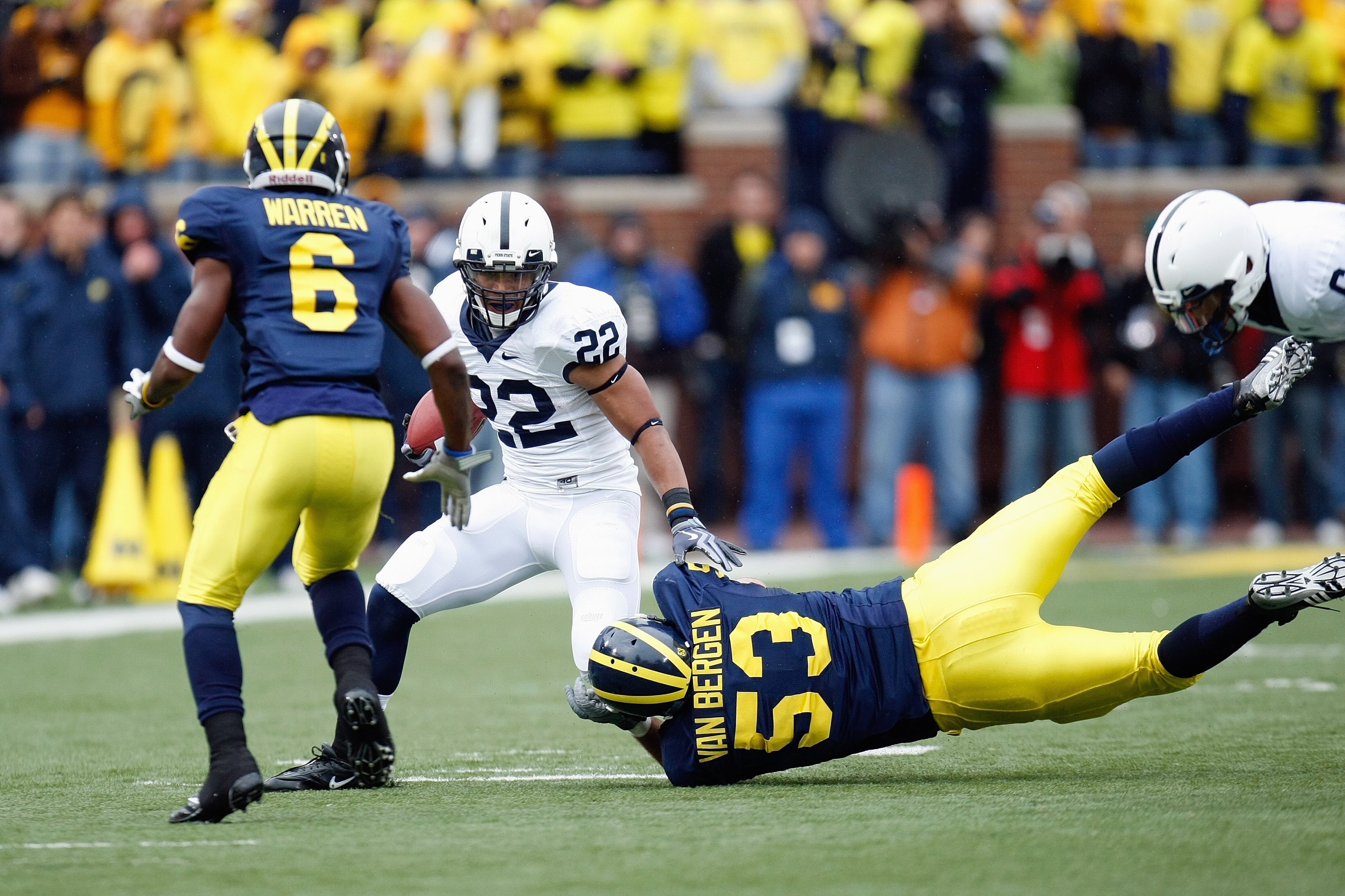 ANN ARBOR, MI - OCTOBER 24:  Evan Royster #22 of the Penn State Nittany Lions carries the ball against Donovan Warren #6 and Ryan Van Bergen #53 of the Michigan Wolverines on October 24, 2009 at Michigan Stadium in Ann Arbor, Michigan. (Photo by  Gregory