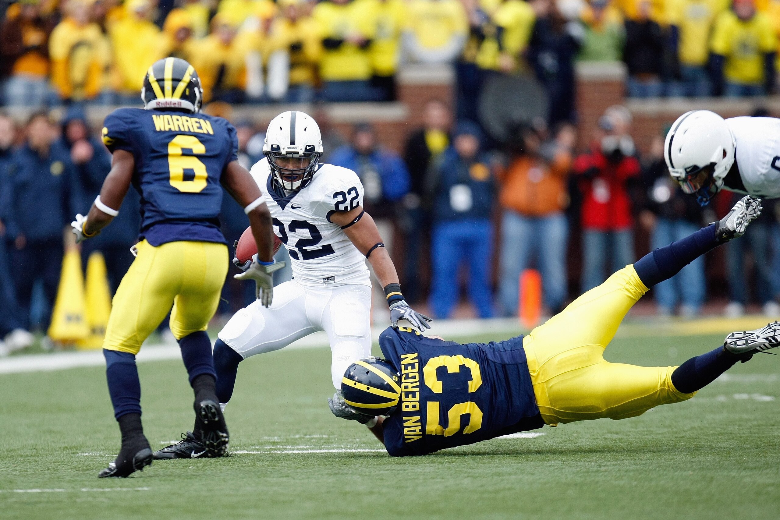 ANN ARBOR, MI - OCTOBER 24:  Evan Royster #22 of the Penn State Nittany Lions carries the ball against Donovan Warren #6 and Ryan Van Bergen #53 of the Michigan Wolverines on October 24, 2009 at Michigan Stadium in Ann Arbor, Michigan. (Photo by  Gregory