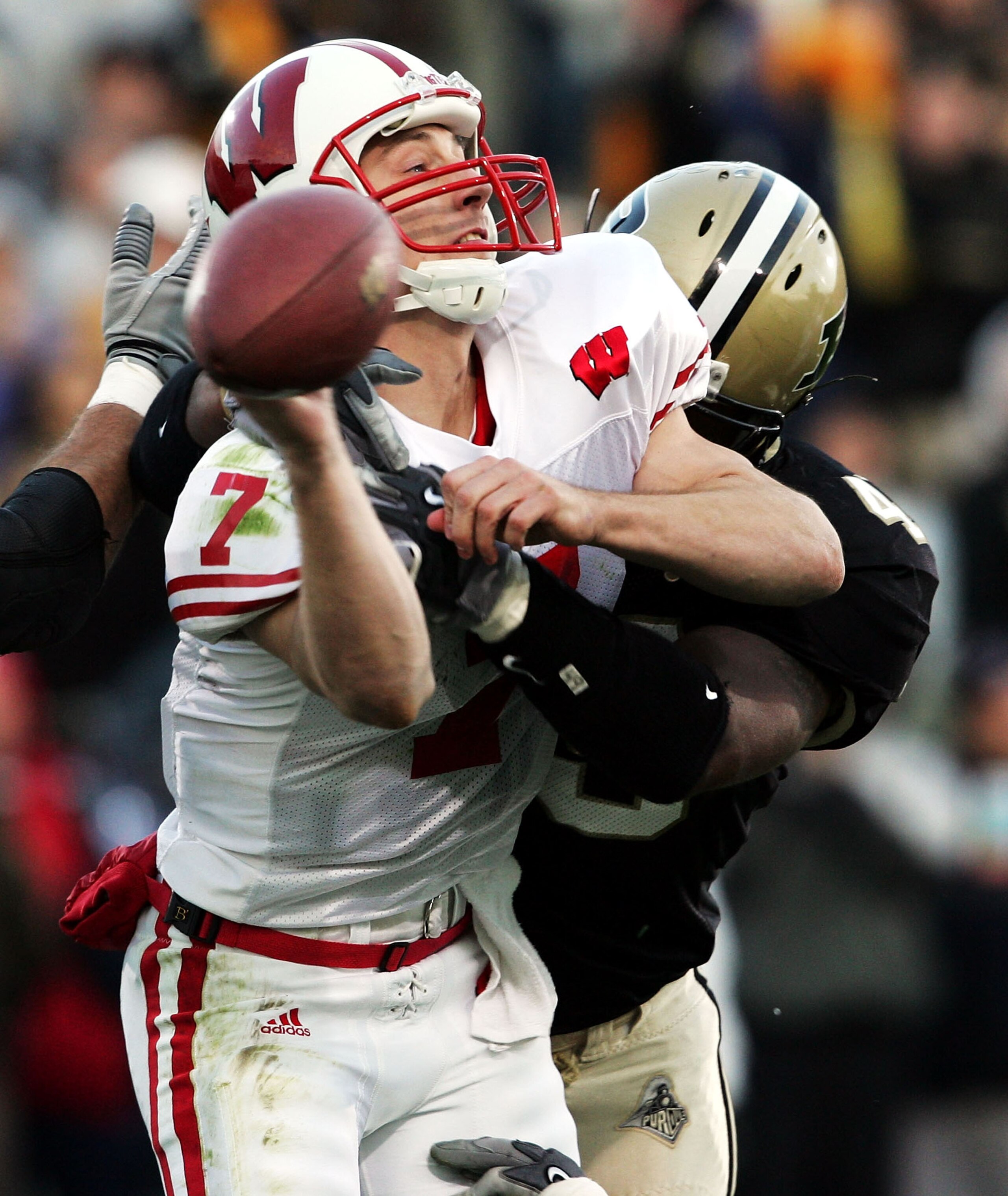 WEST LAYFAYETTE, IN - OCTOBER 16:  John Stocco #7 of Wisconsin throws the ball while being hit by Anthony Spencer #49 of Purdue  during the game at Ross-Ade Stadium on October 16, 2004 in West Lafayette, Indiana.    (Photo by Andy Lyons/Getty Images)