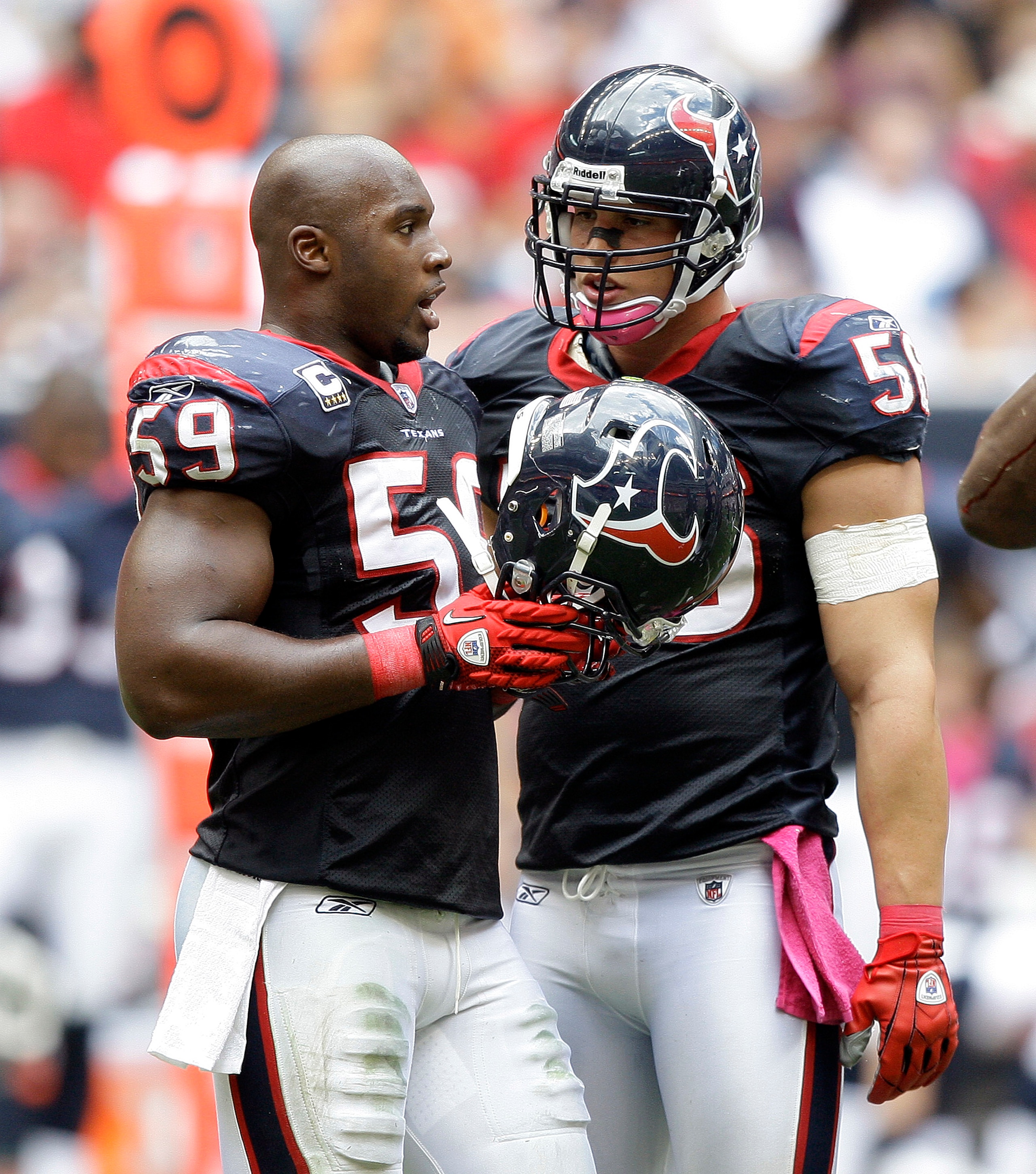 HOUSTON - OCTOBER 17:  DeMeco Ryans #59 and Brian Cushing #56 of the Houston Texans talk during a break in the play during  a game against the Kansas City Chiefs at Reliant Stadium on October 17, 2010 in Houston, Texas.  (Photo by Bob Levey/Getty Images)