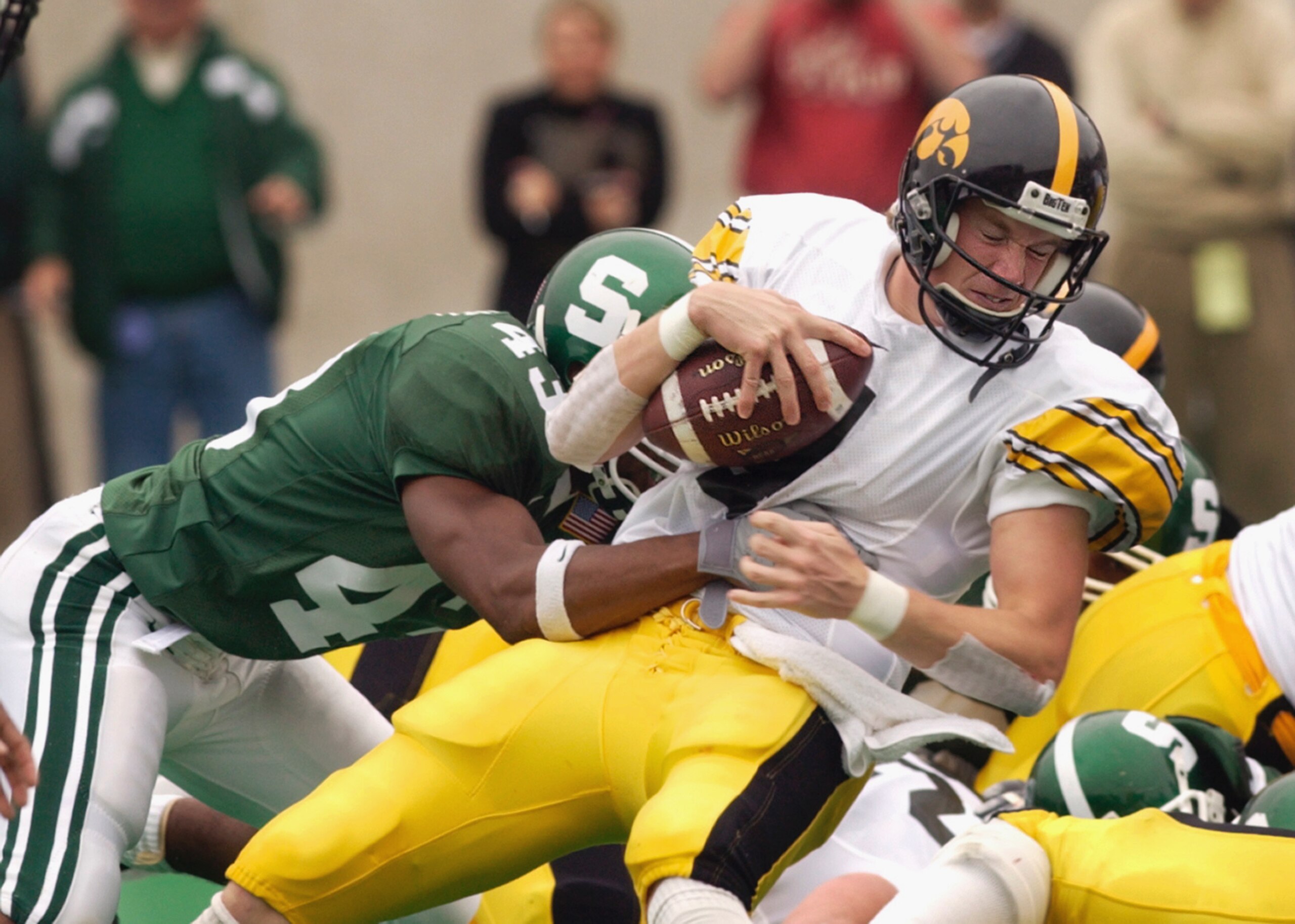 EAST LANSING, MI - OCTOBER 13:  Safety Thomas Wright #43 of the Michigan State Spartans sacks quarterback Kyle McCann #4 of the Iowa Hawkeyes during the Big Ten Conference football game on October 13, 2001 at Spartan Stadium in East Lansing, Michigan. The
