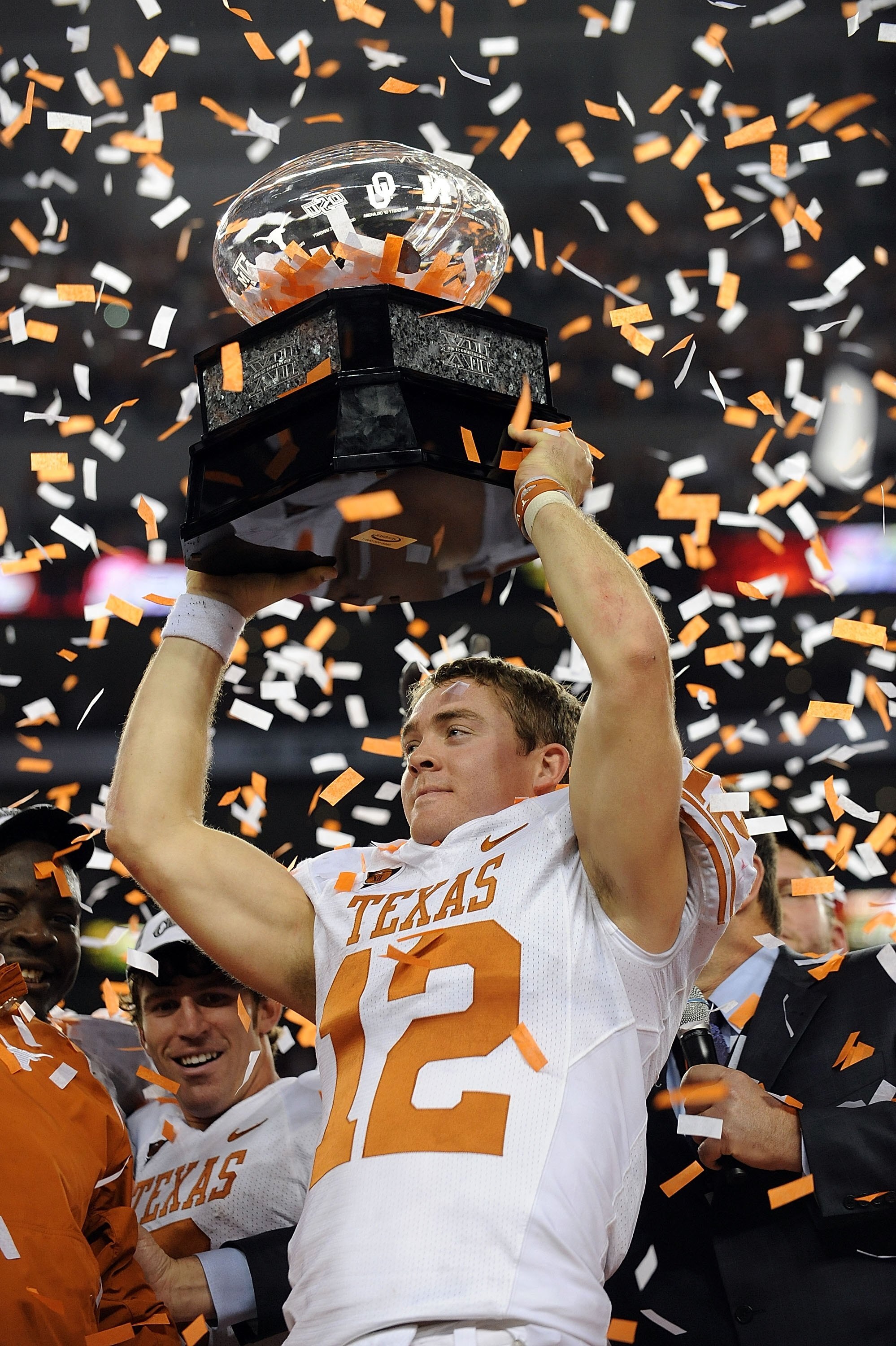 ARLINGTON, TX - DECEMBER 05:  Quarterback Colt McCoy #12 of the Texas Longhorns lifts the Big 12 Championship trophy at Cowboys Stadium on December 5, 2009 in Arlington, Texas.  (Photo by Ronald Martinez/Getty Images)