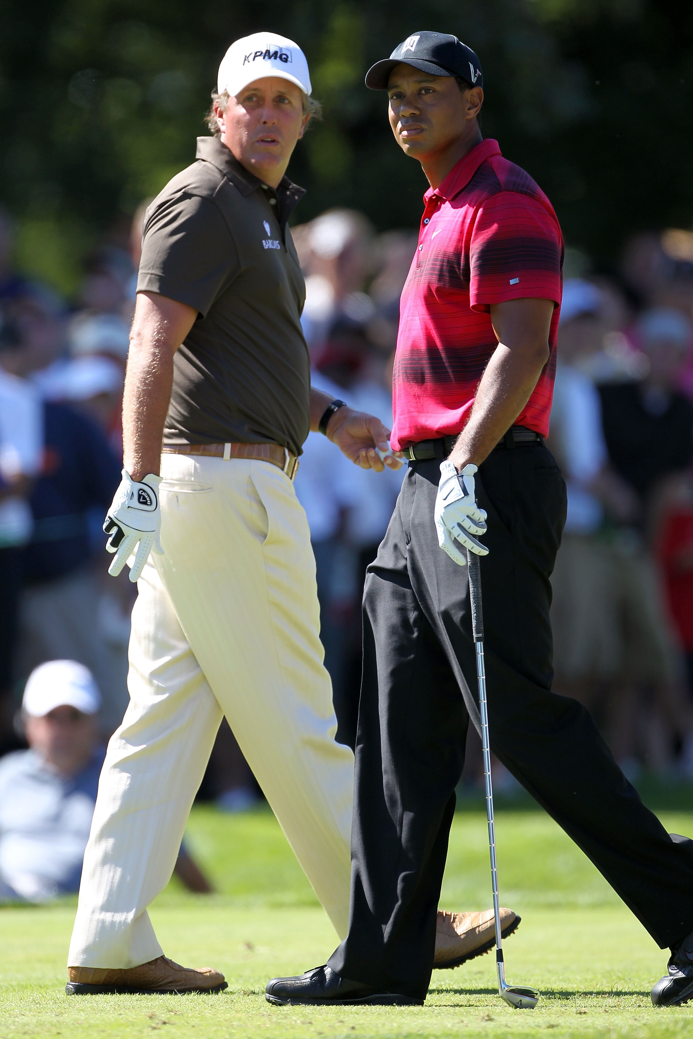 LEMONT, IL - SEPTEMBER 12:  Phil Mickelson and Tiger Woods pass each other by on the second hole during the final round of the BMW Championship at Cog Hill Golf & Country Club on September 12, 2010 in Lemont, Illinois.  (Photo by Jamie Squire/Getty Images