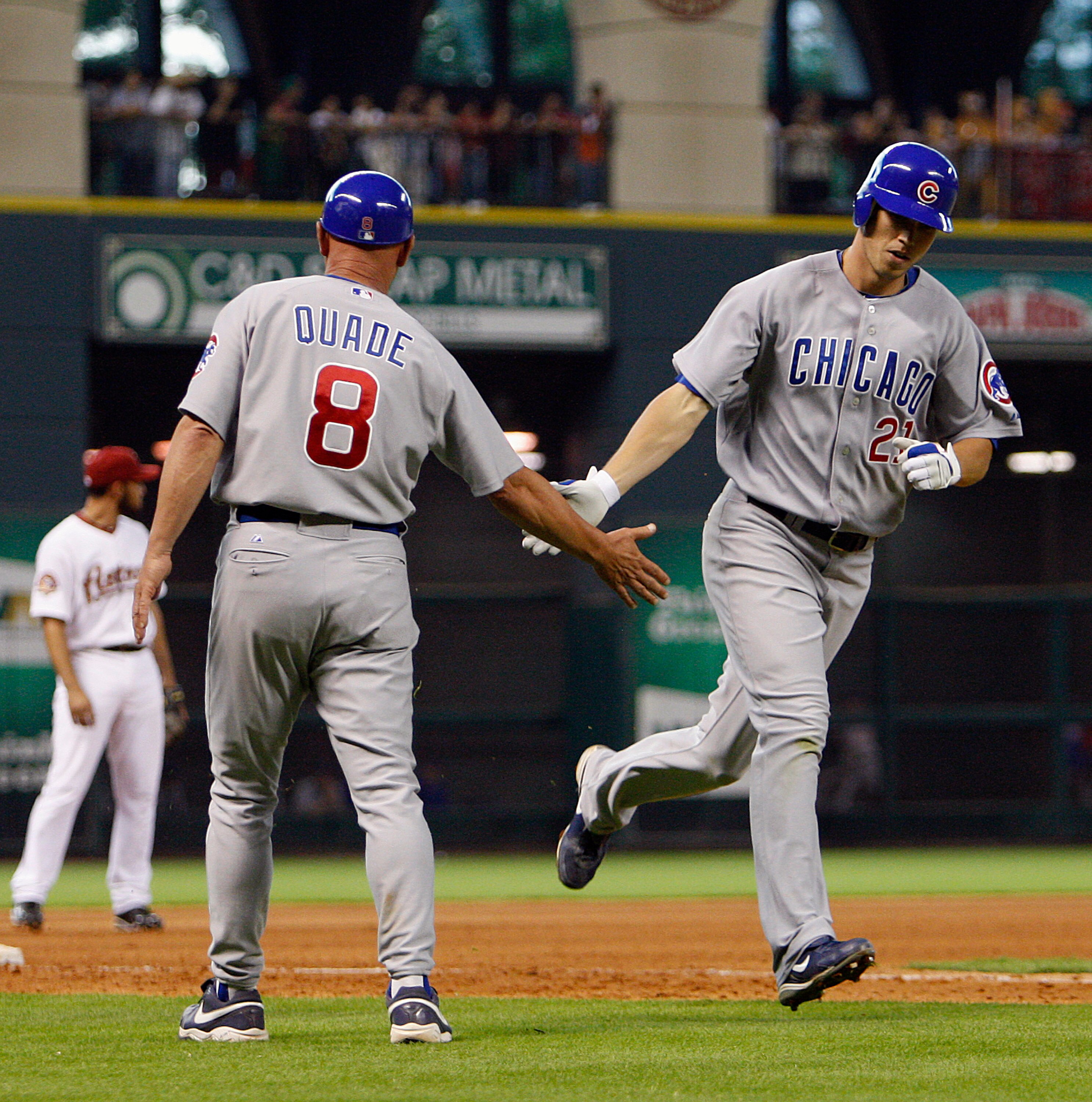 HOUSTON - JUNE 05:  Tyler Colvin #21 of the Chicago Cubs is congratulated by third base coach Mike Quade after hitting a home run against the Houston Astros at Minute Maid Park on June 5, 2010 in Houston, Texas.  (Photo by Bob Levey/Getty Images)